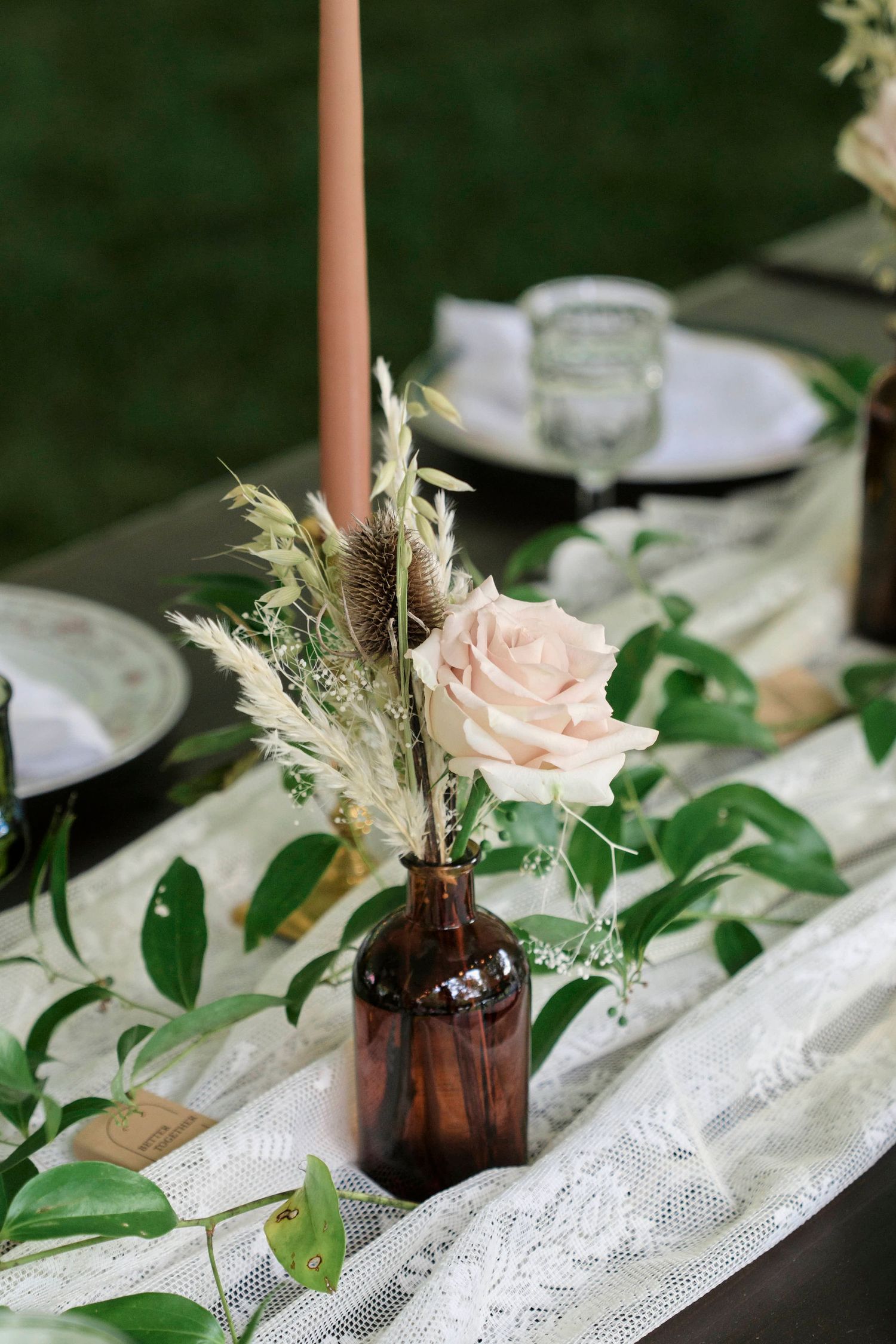 details of a flower on the table of an outdoor alfresco style wedding.