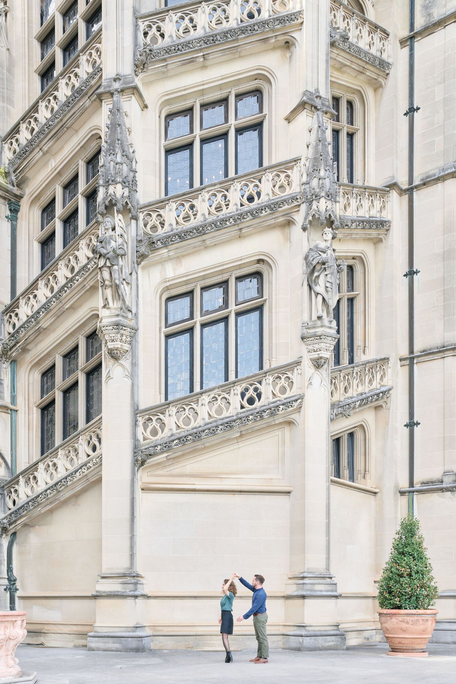 Couple dancing in front of the Biltmore house for their engagement photos.