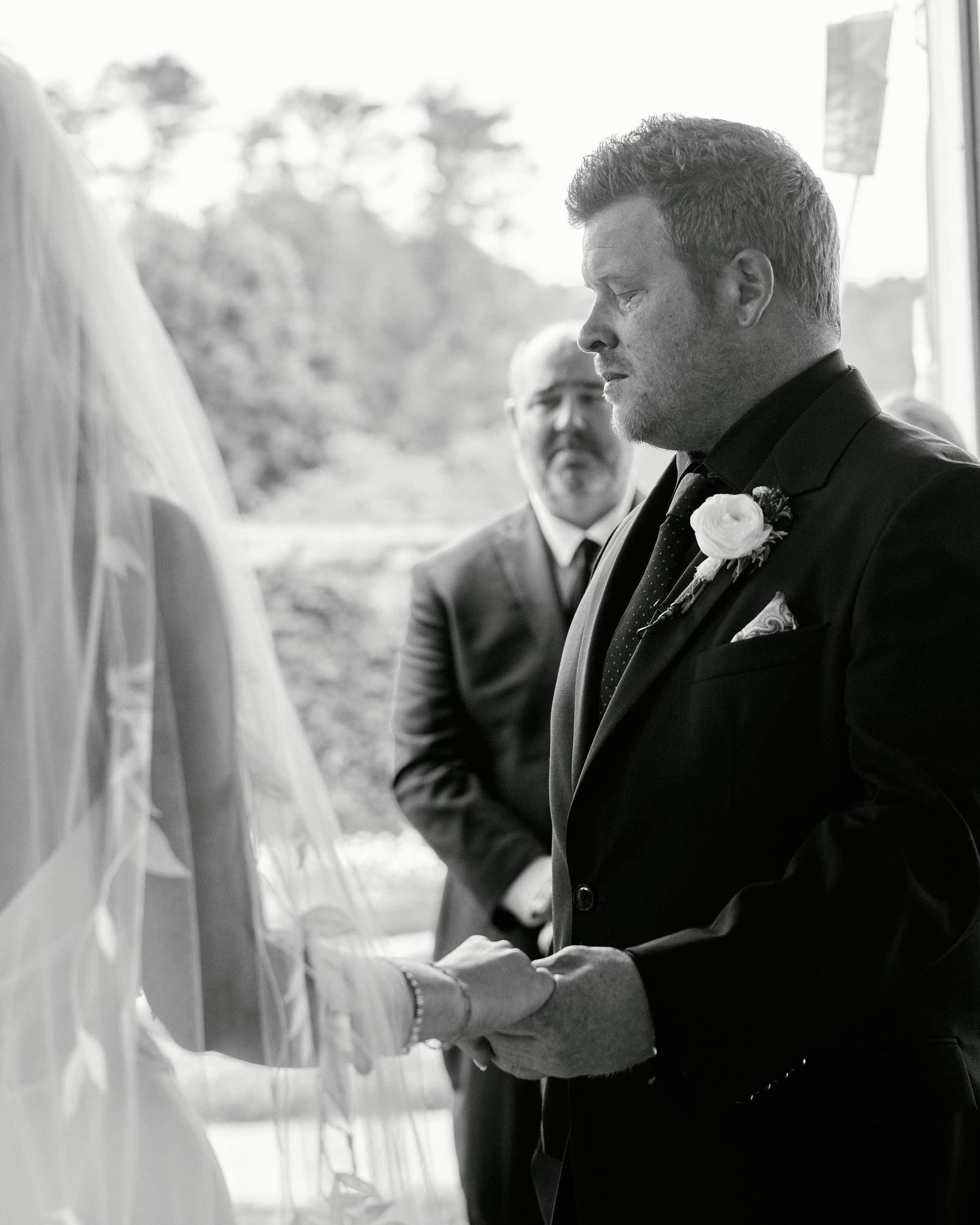 A series of black and white photos showing two people in formal attire having an animated conversation at an event.