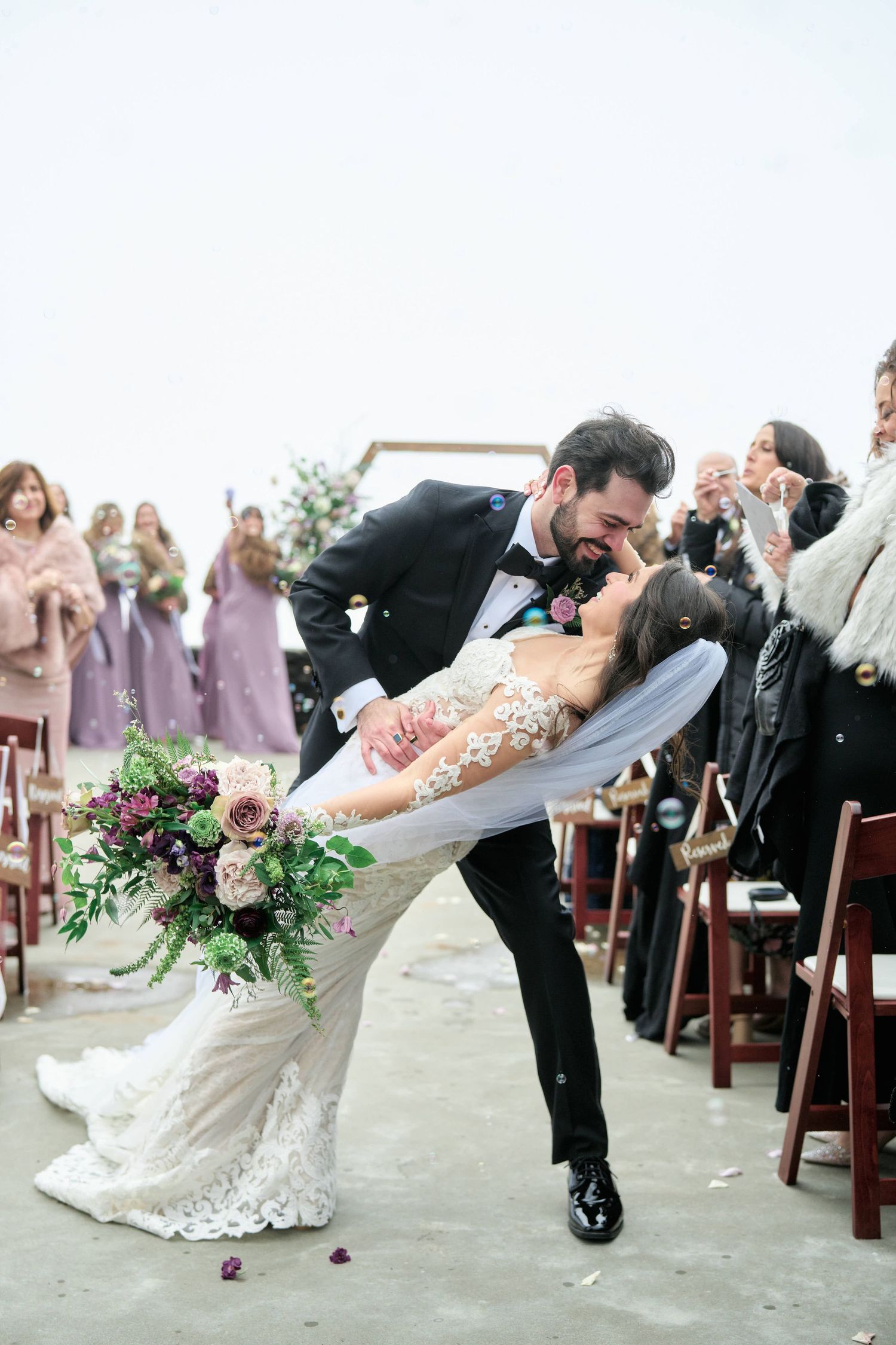 Groom dipping the Bride as they exit their ceremony at the twickenham House wedding venue