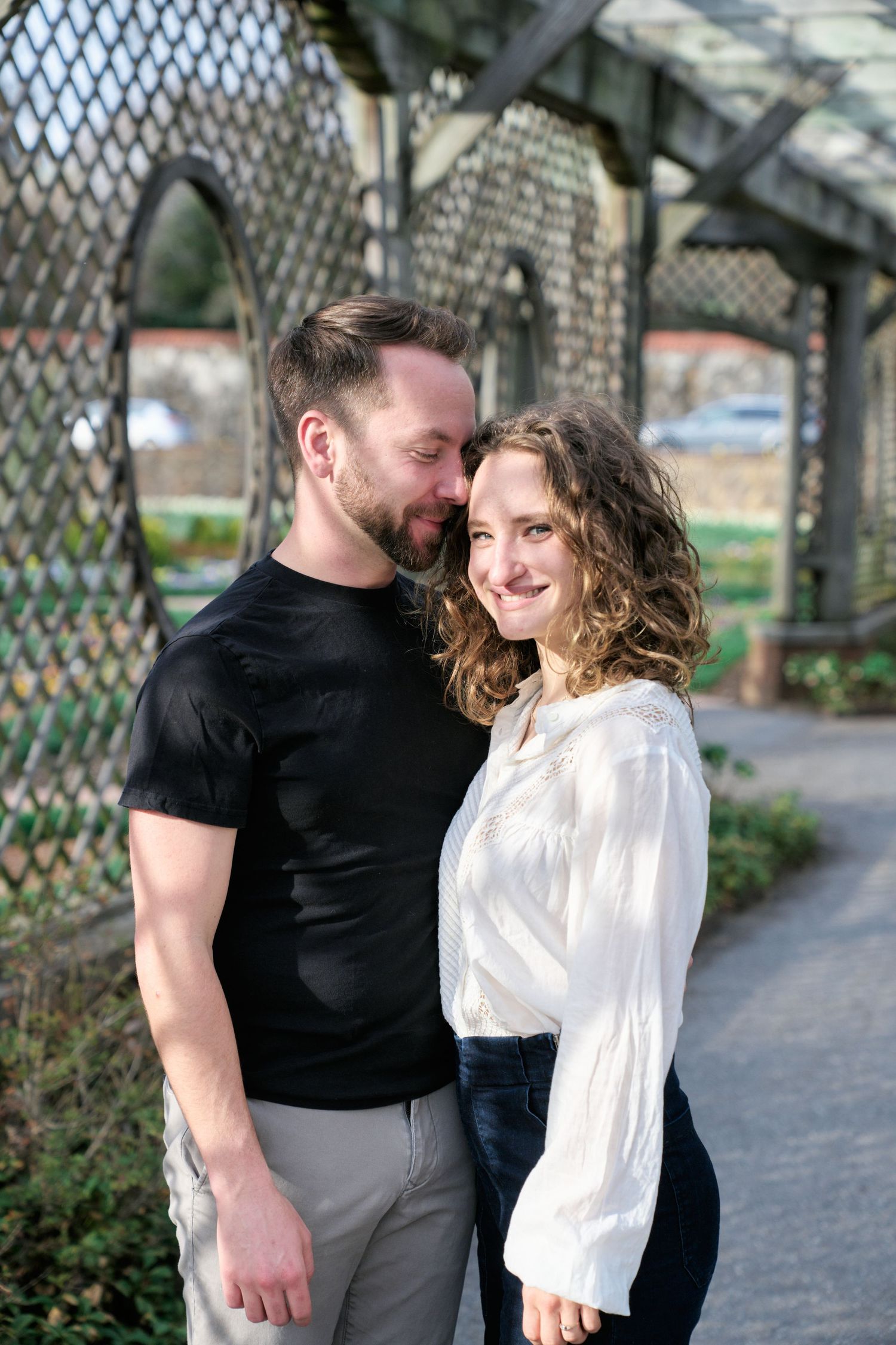 Couple hugging at the Biltmore gardens during their engagement session.
