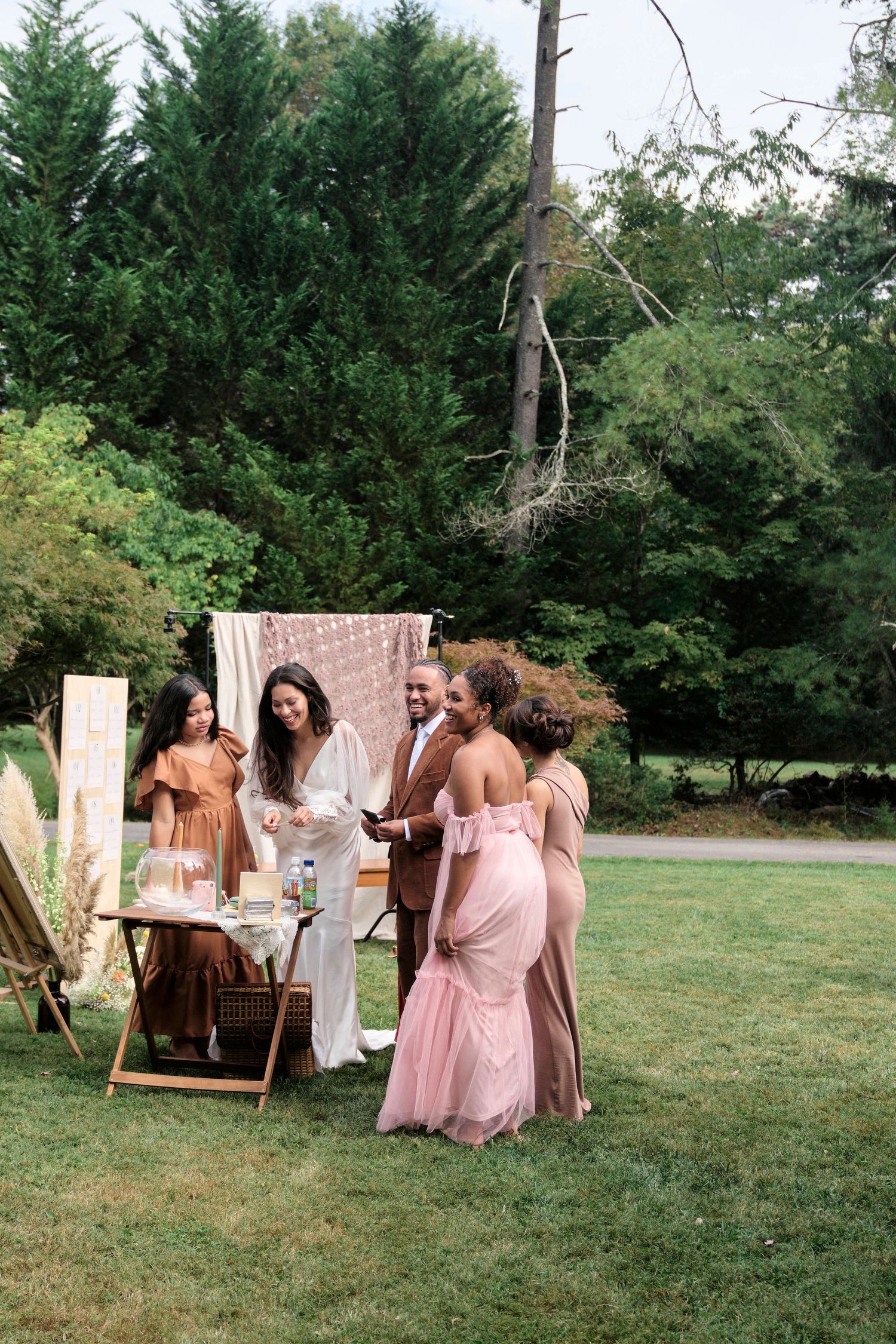 Bride and groom laughing with friends about a photo they took.