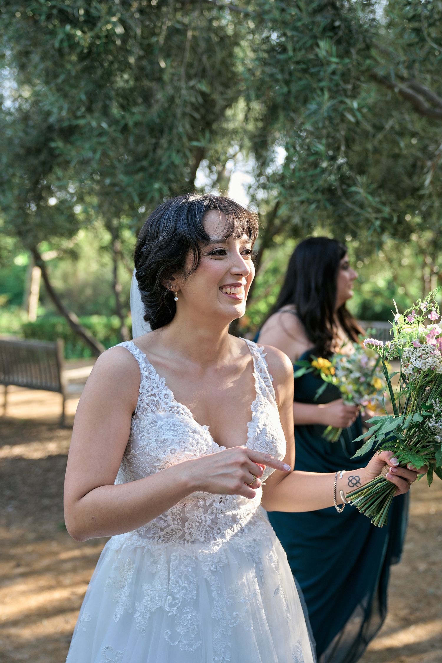 A candid wedding moment captured in a garden setting with natural lighting.