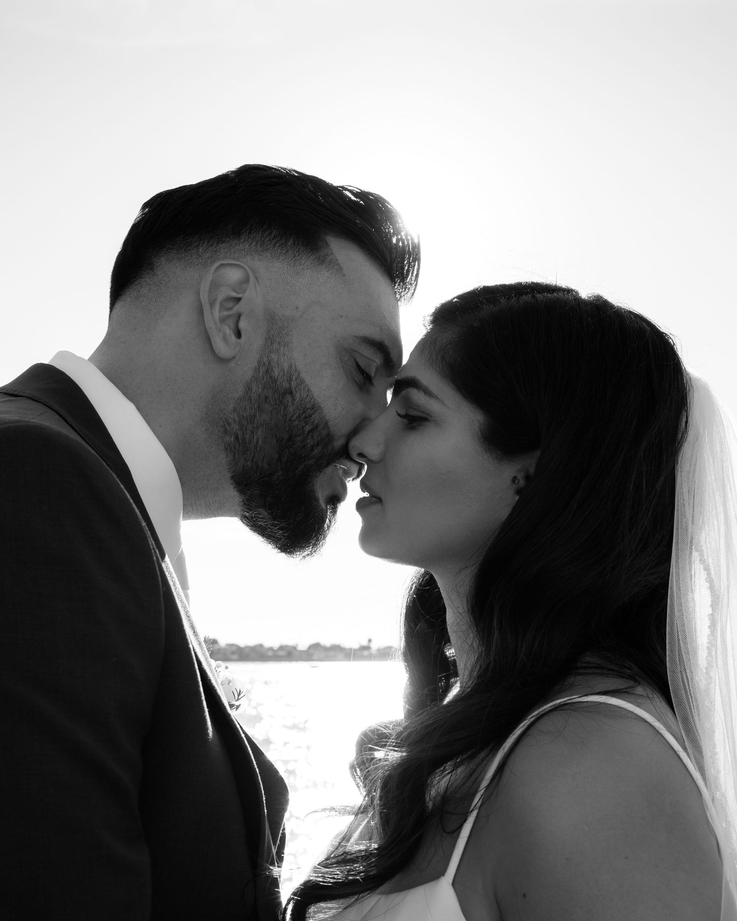 A romantic black and white photo series showing a couple in wedding attire sharing intimate moments together.