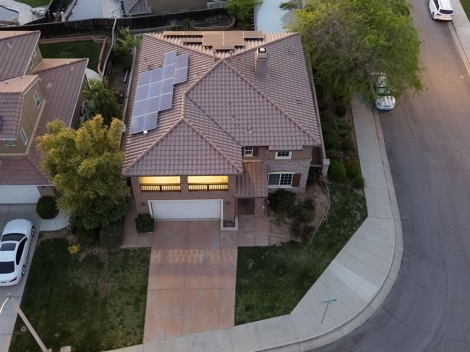 Aerial view of suburban neighborhood with curved streets and Mediterranean-style homes.