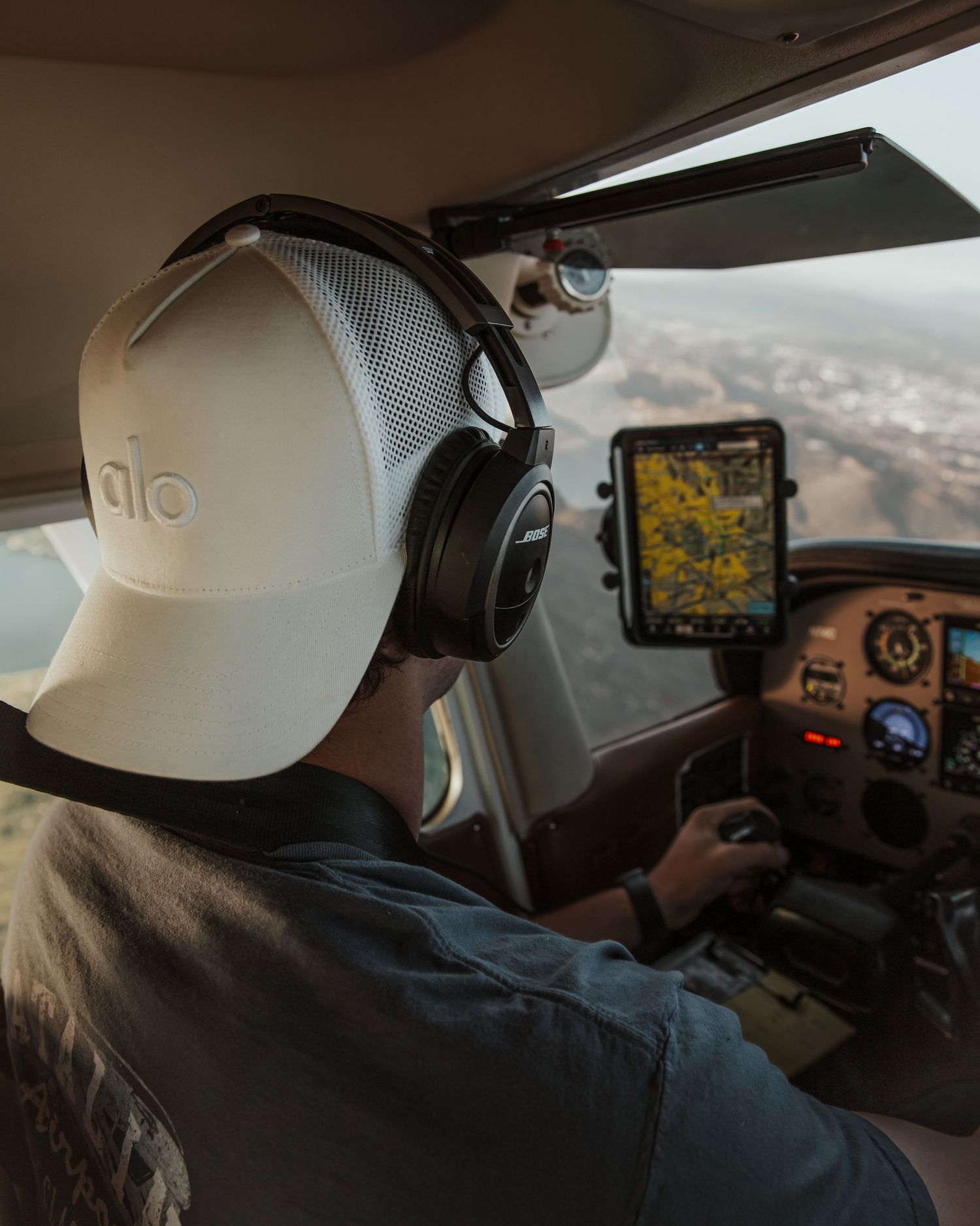 Pilots operating aircraft controls in cockpit during flight.