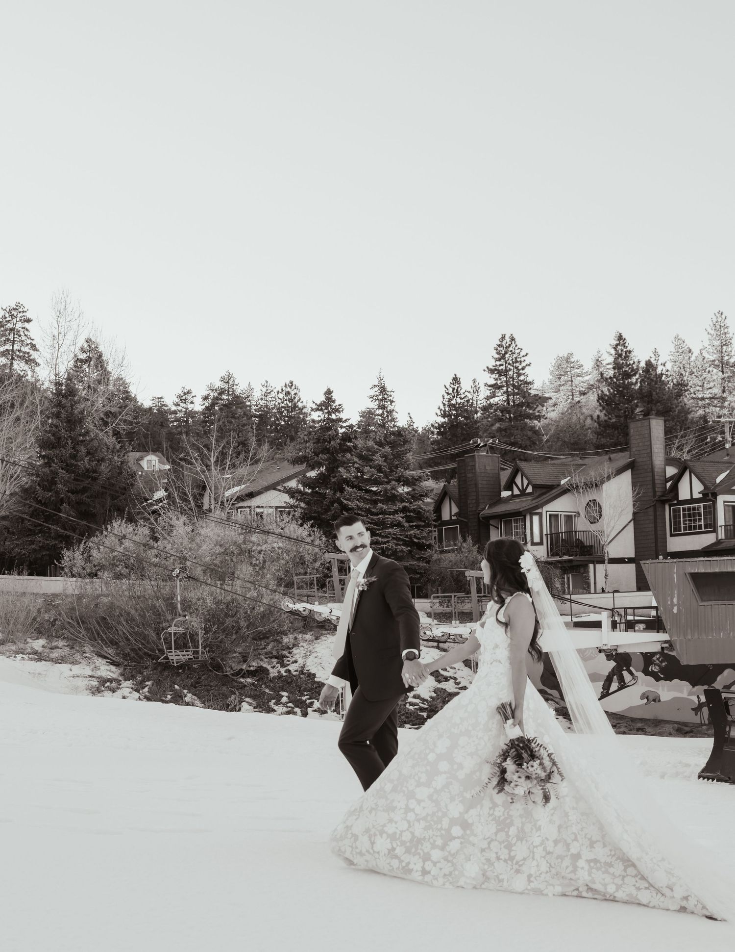 Black and white wedding photography in a snowy winter landscape.