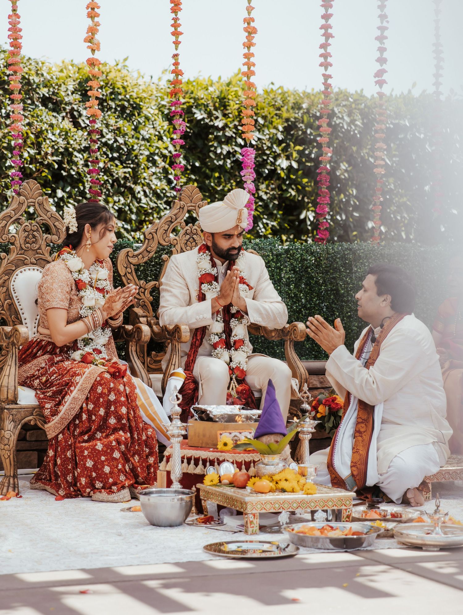 Traditional Indian wedding ceremony with colorful floral decorations and food offerings.