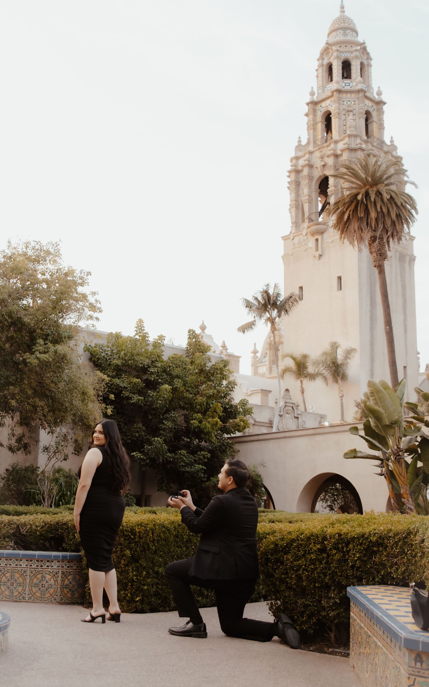 Beautiful Spanish colonial style church with white towers and palm trees during a proposal moment.