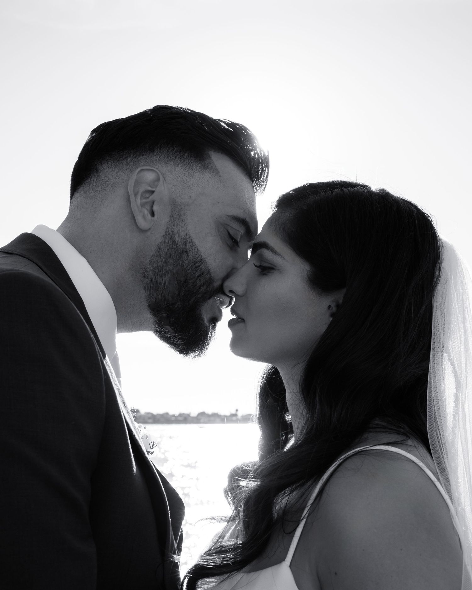 Intimate black and white wedding portraits captured in dramatic silhouette.