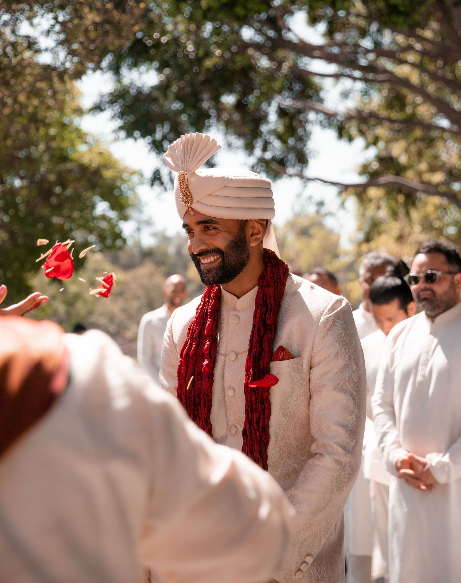 Traditional Indian wedding ceremony with guests in white attire.