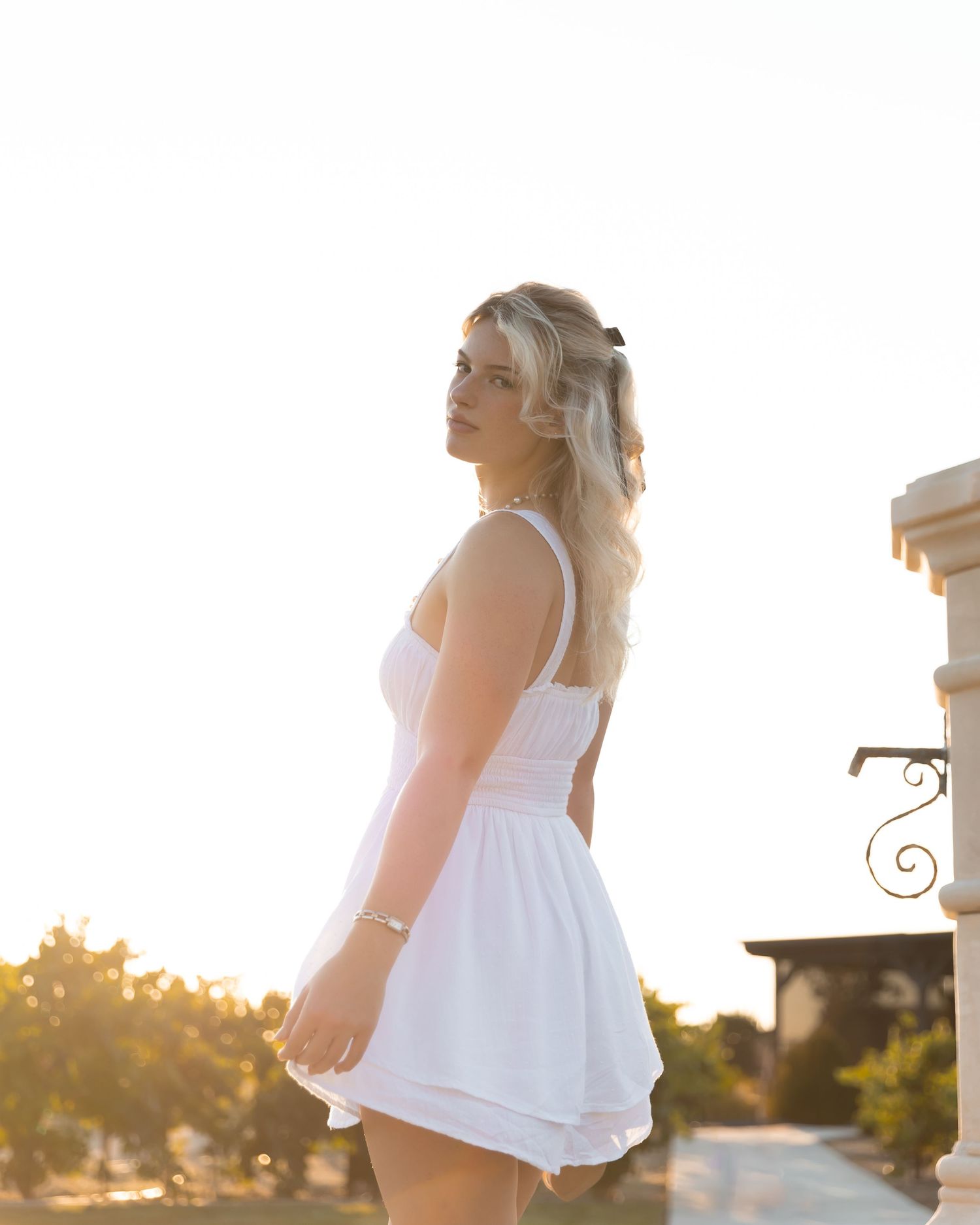 Ethereal outdoor portrait session featuring a flowing white dress at sunset.