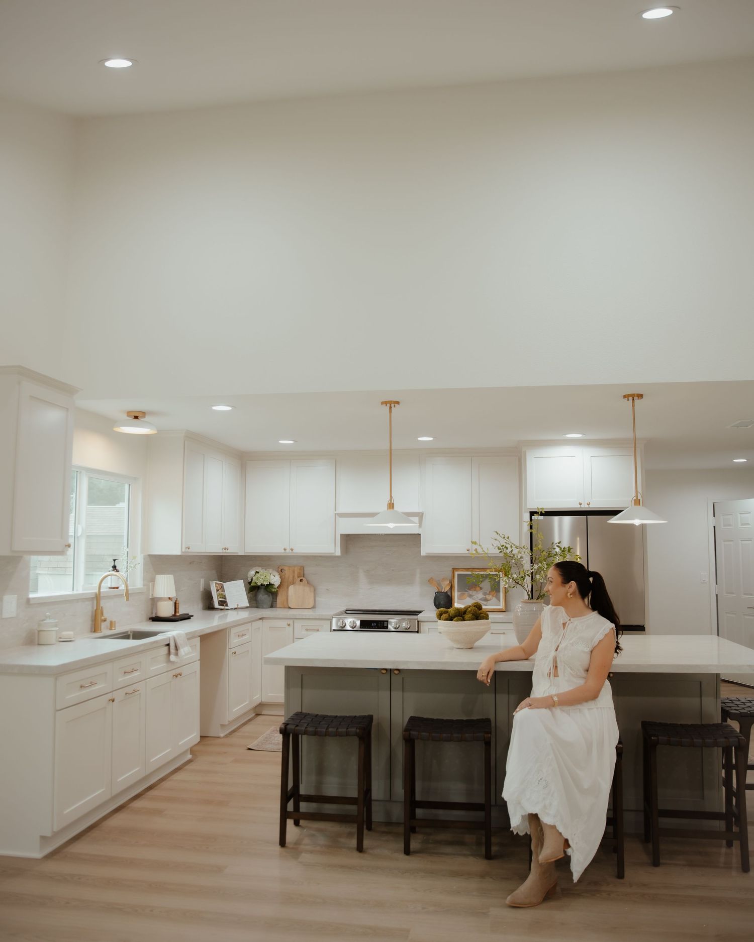 Bright modern kitchen interior with white cabinets and minimalist design elements.