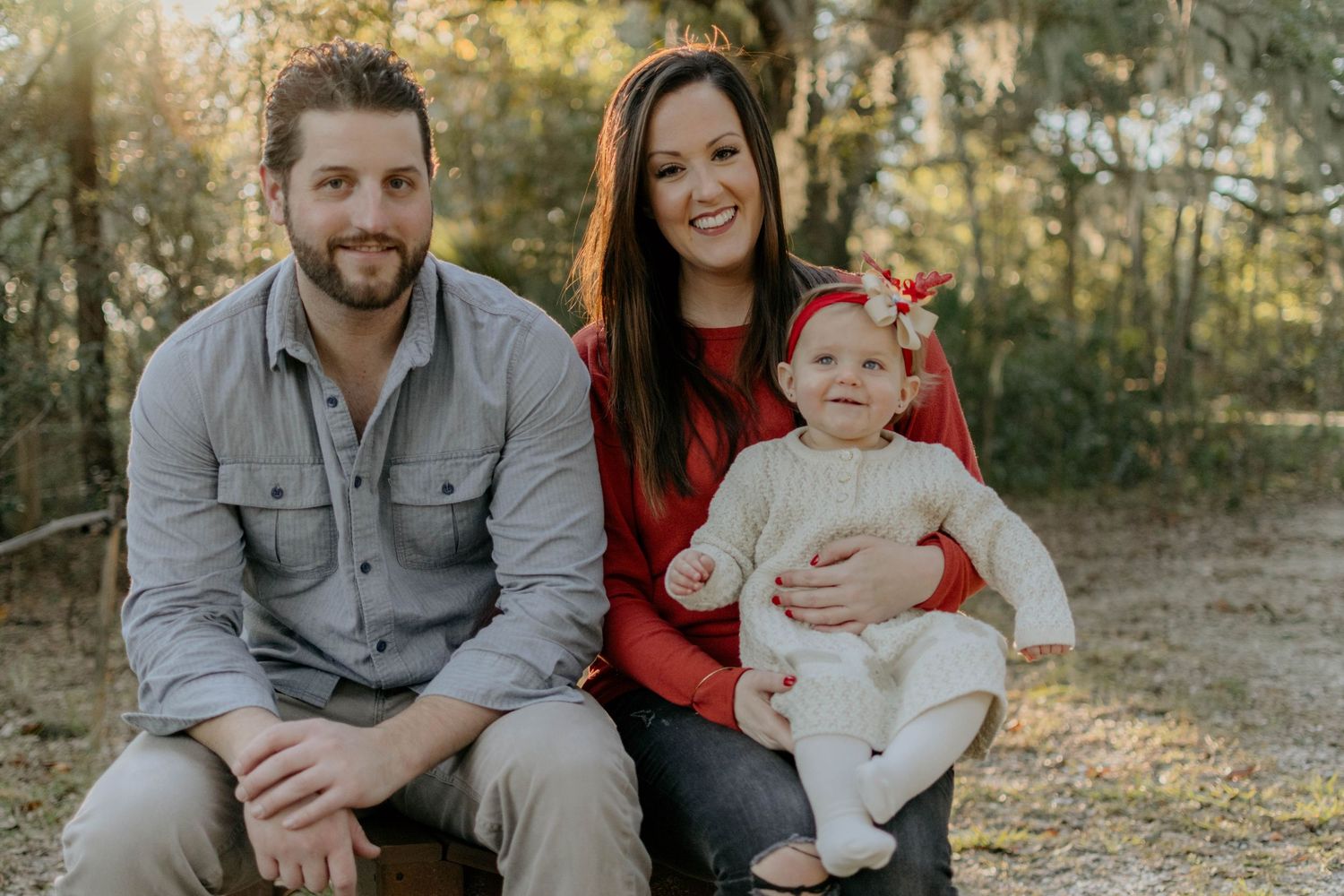Family sitting together outdoors during a relaxed natural light lifestyle photography session