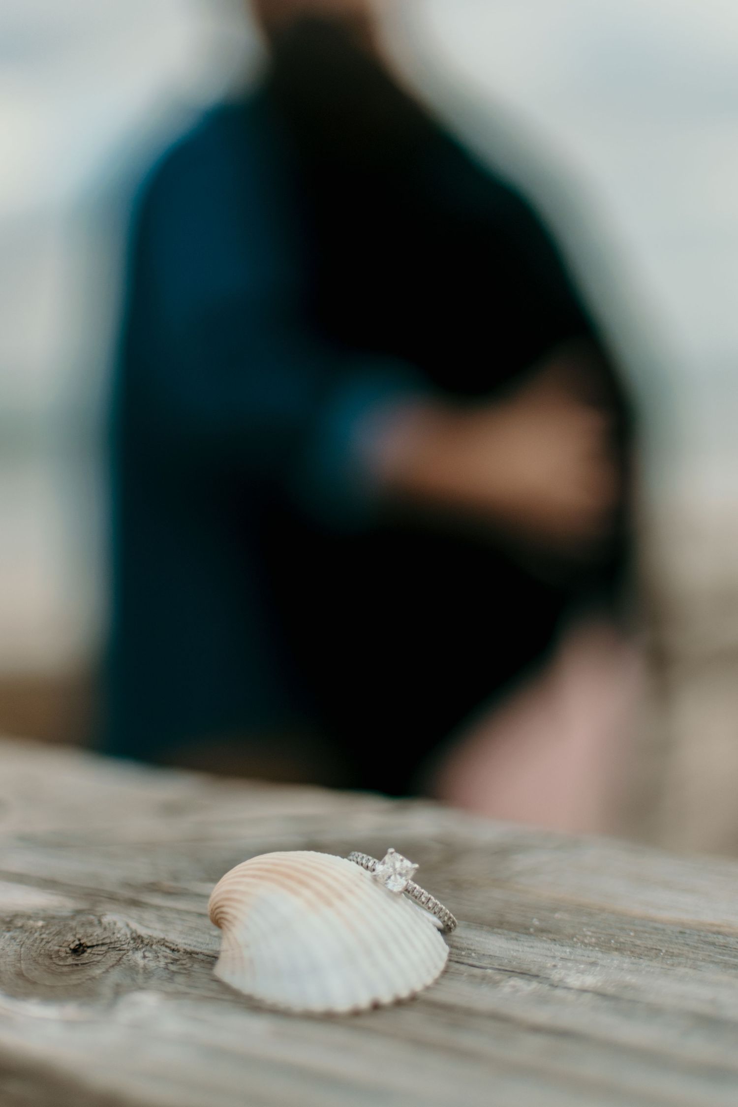 Soft blurred lifestyle ring detail image with warm tones capturing an intimate candid moment
