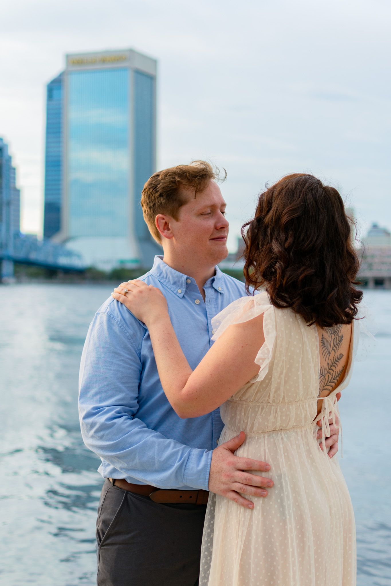 Couple embracing in an urban setting during a modern lifestyle engagement photoshoot