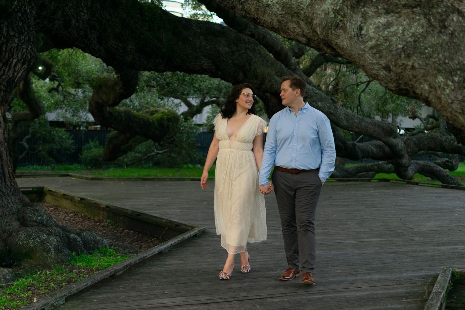 Couple engagement session between tree background