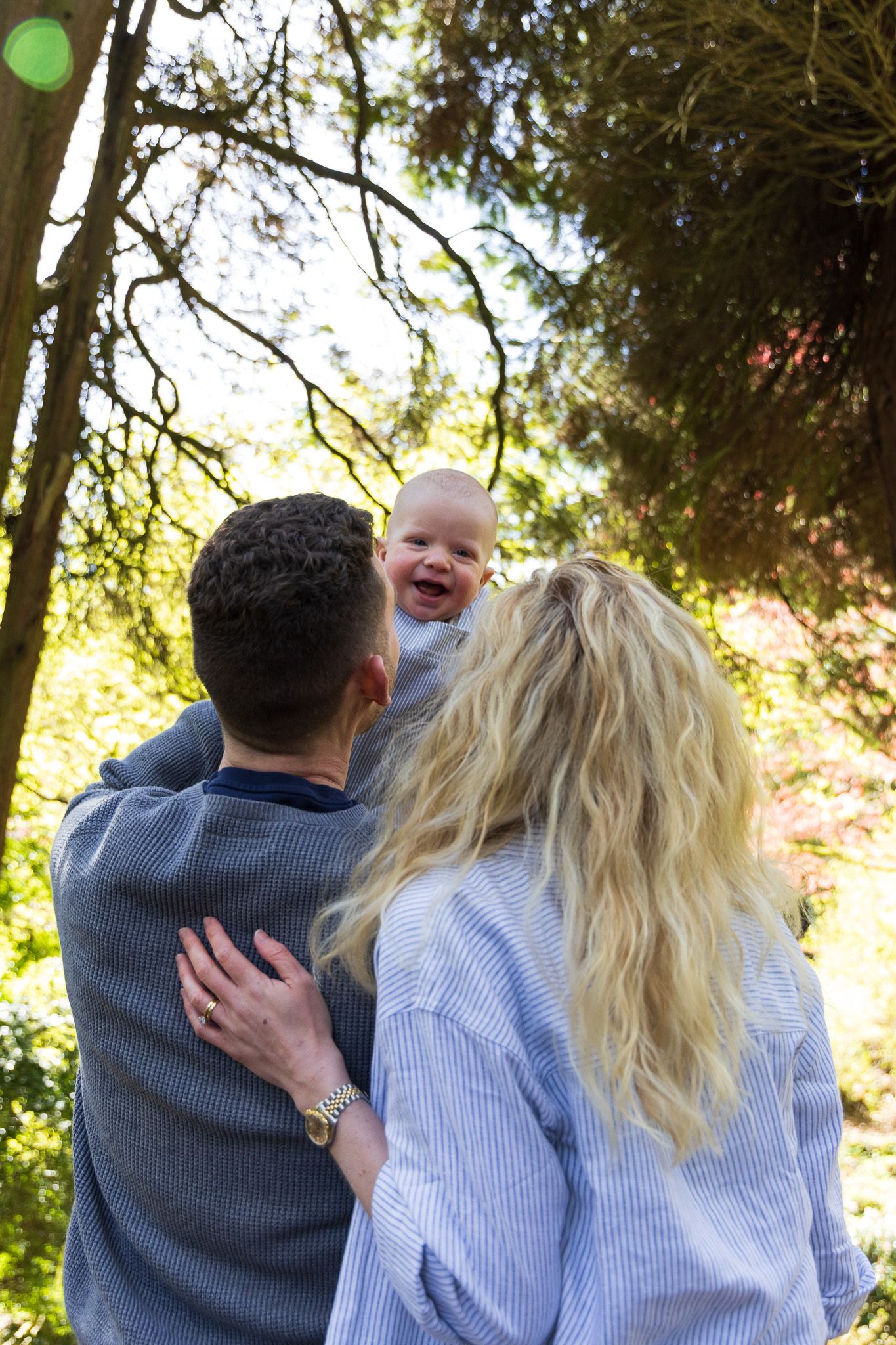 Father embracing mother from behind outdoors