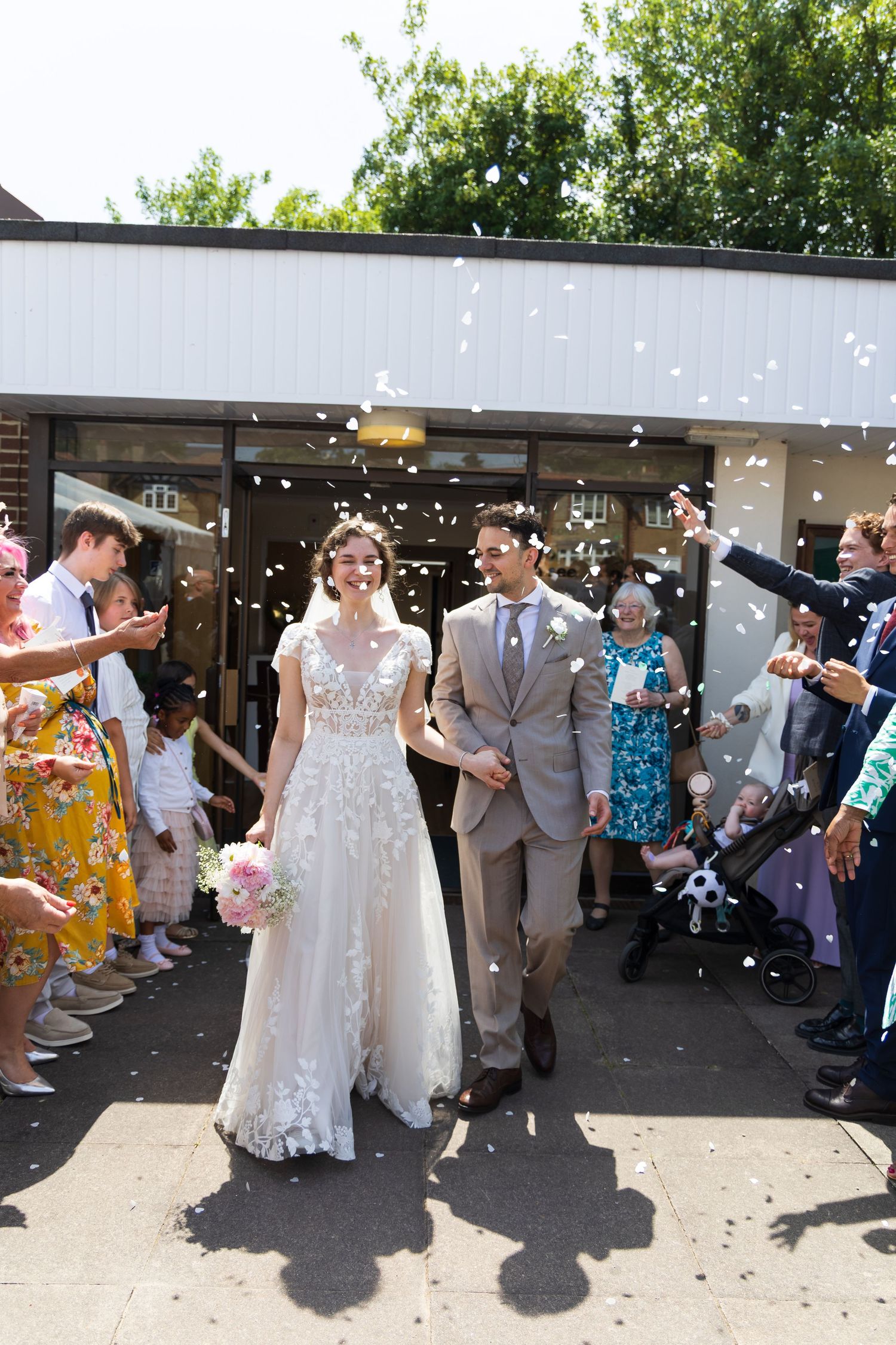Bride walking through a crowd of smiling wedding guests