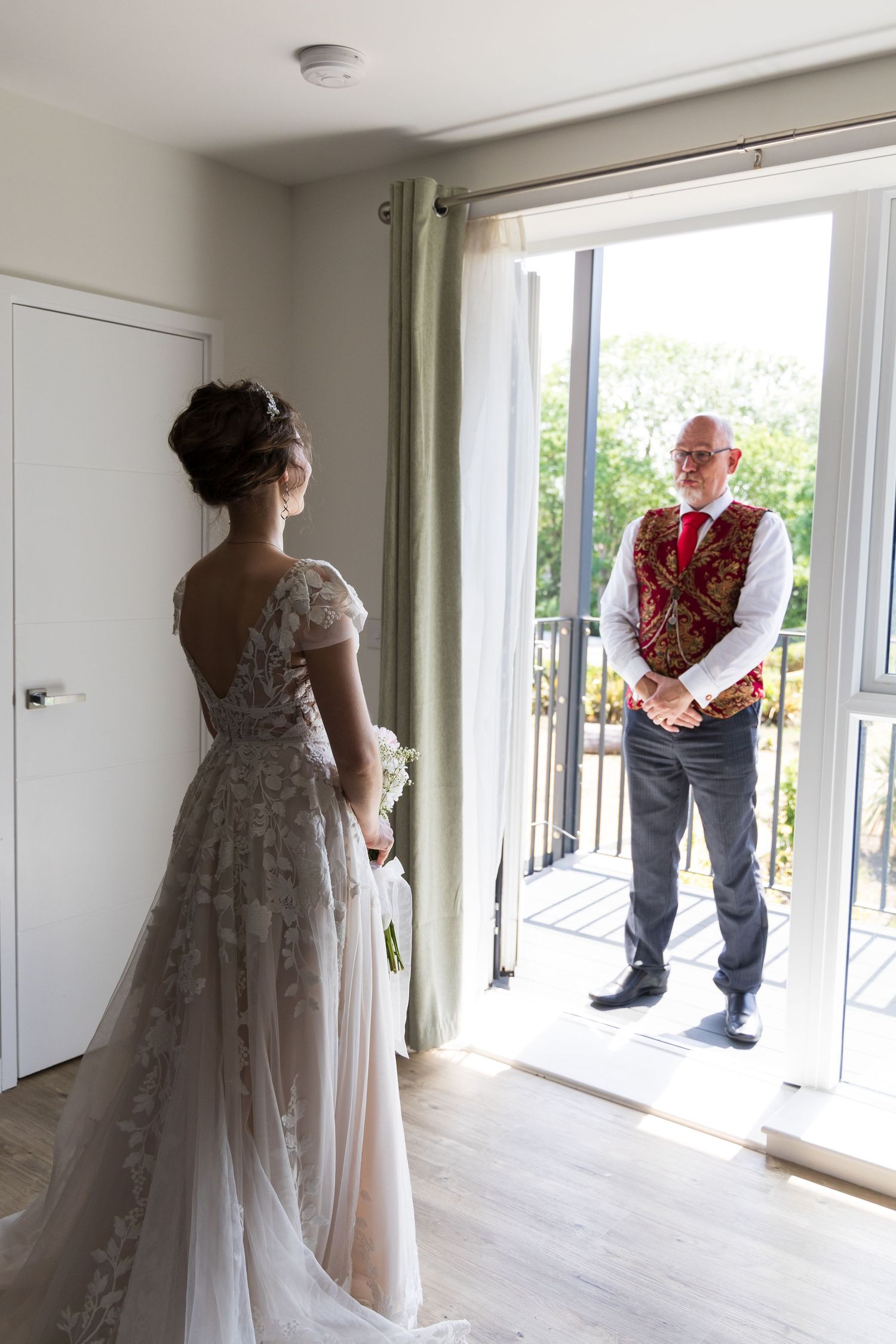 Bride looking out through a doorway before the ceremony