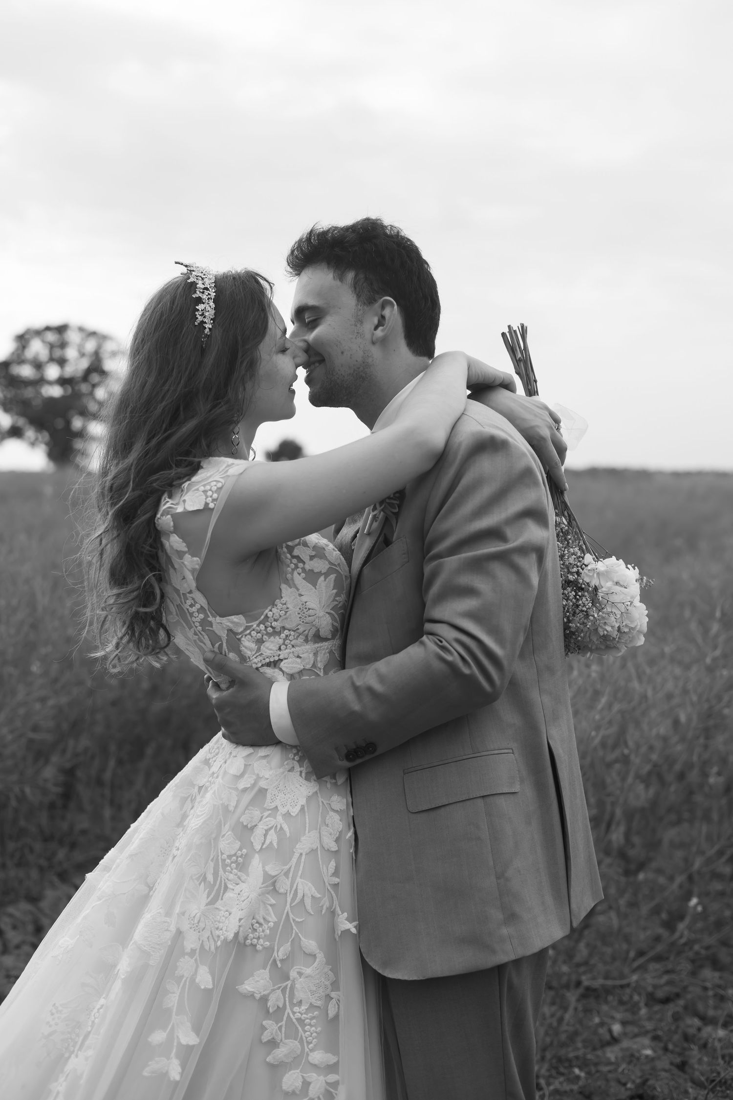 Black and white close-up of bride and groom embracing