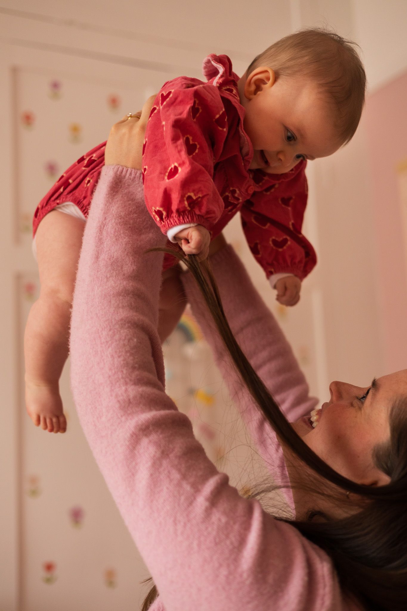 Mother lifting her baby up high