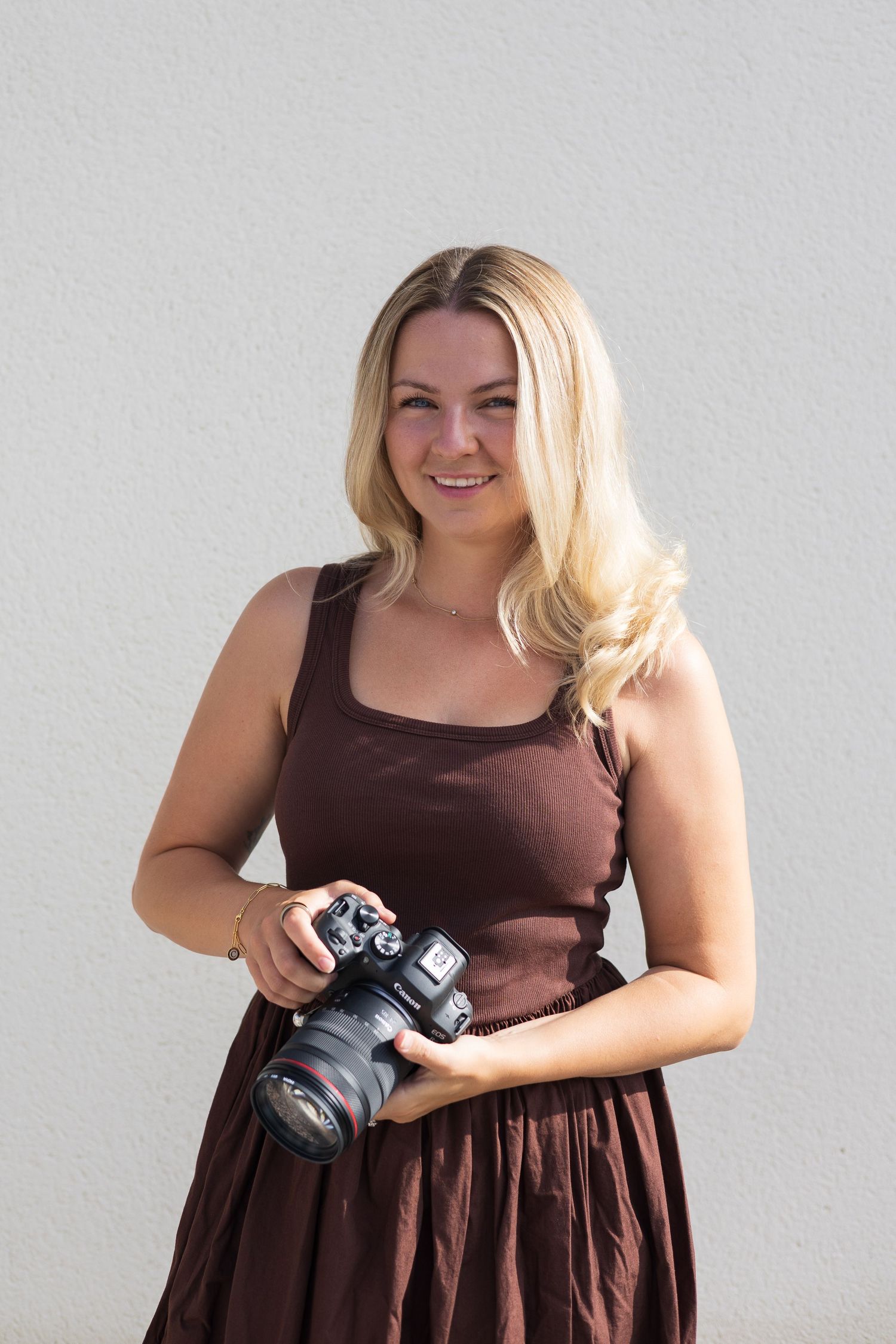 Emily Paige, Cardiff wedding and family photographer, holding a camera