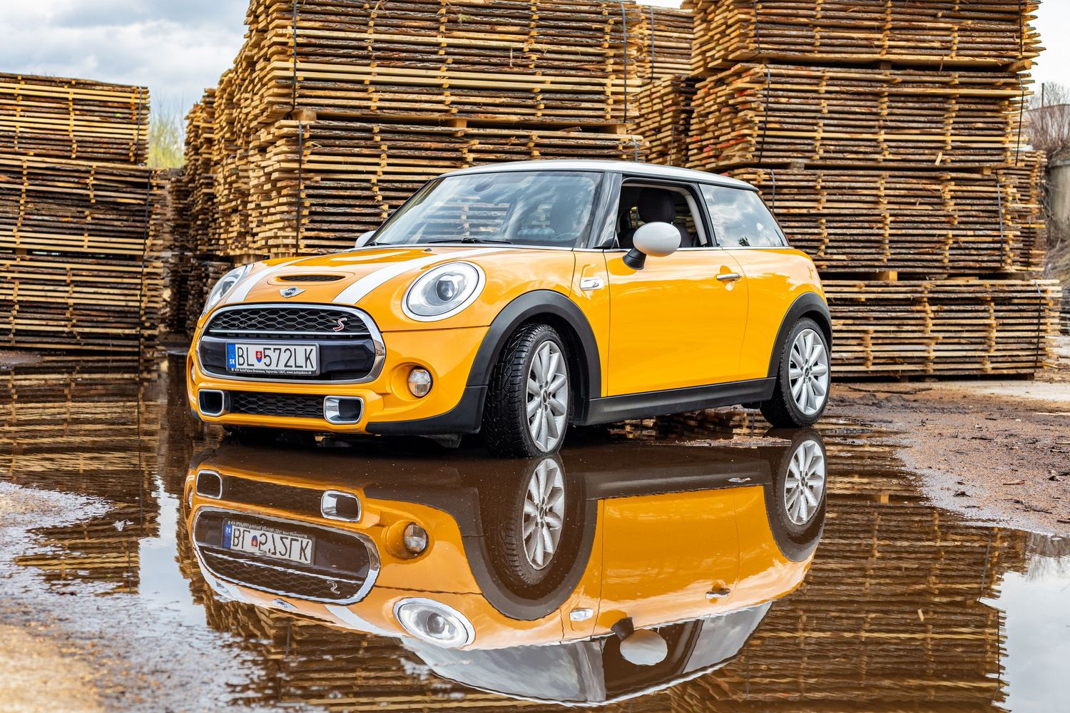 žlté auto s odrazom vo vode