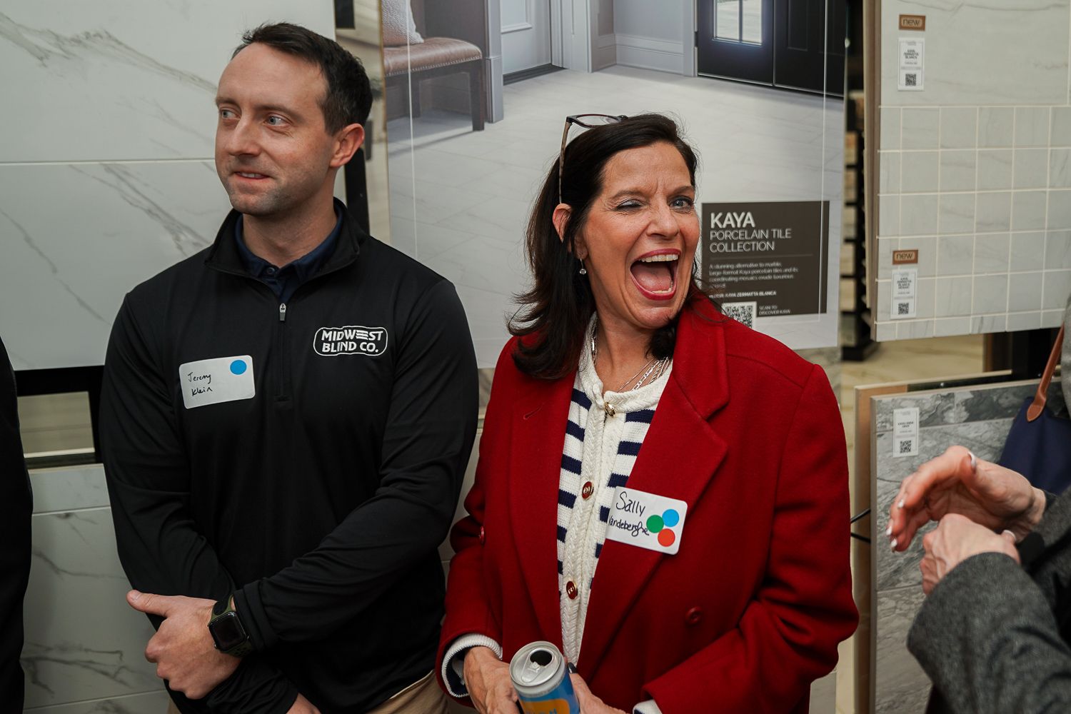 Man and woman reacting with excitement while viewing displays at the BisonHeart, PRO Remodelers, and CenterSphere miser.
