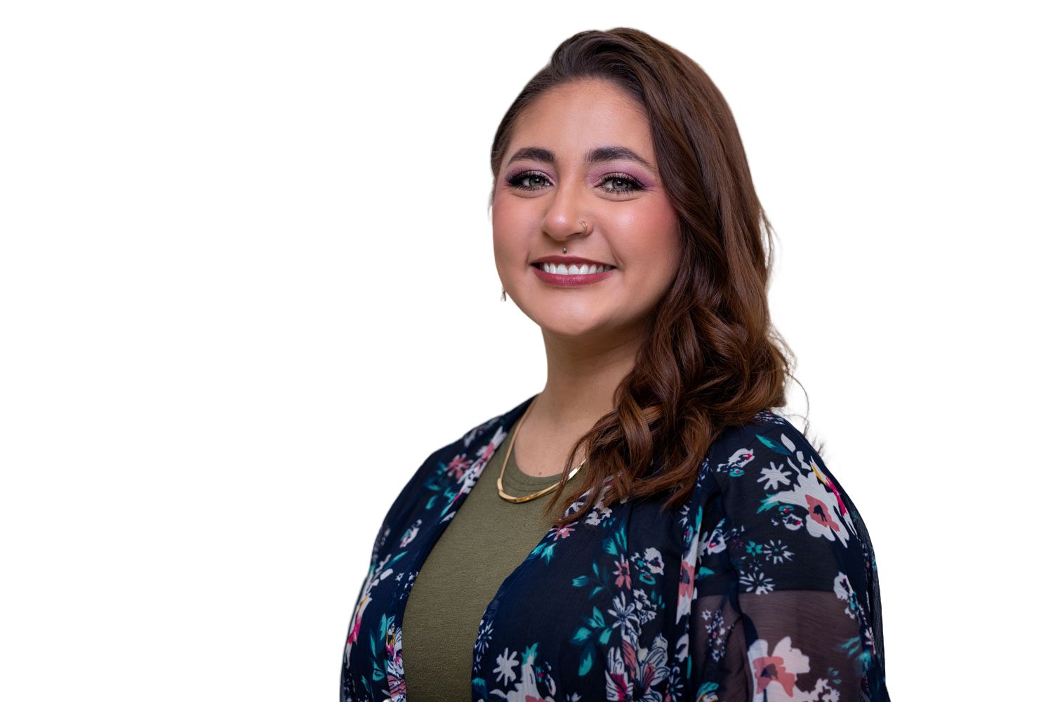 Smiling young woman in floral cardigan and gold necklace posing against a clean white background.