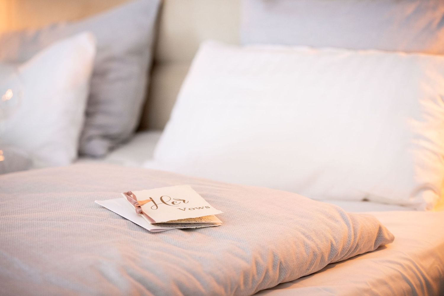 Detail der Karte mit den Hochzeitsversprechen der Braut auf dem Bett während des Getting Ready