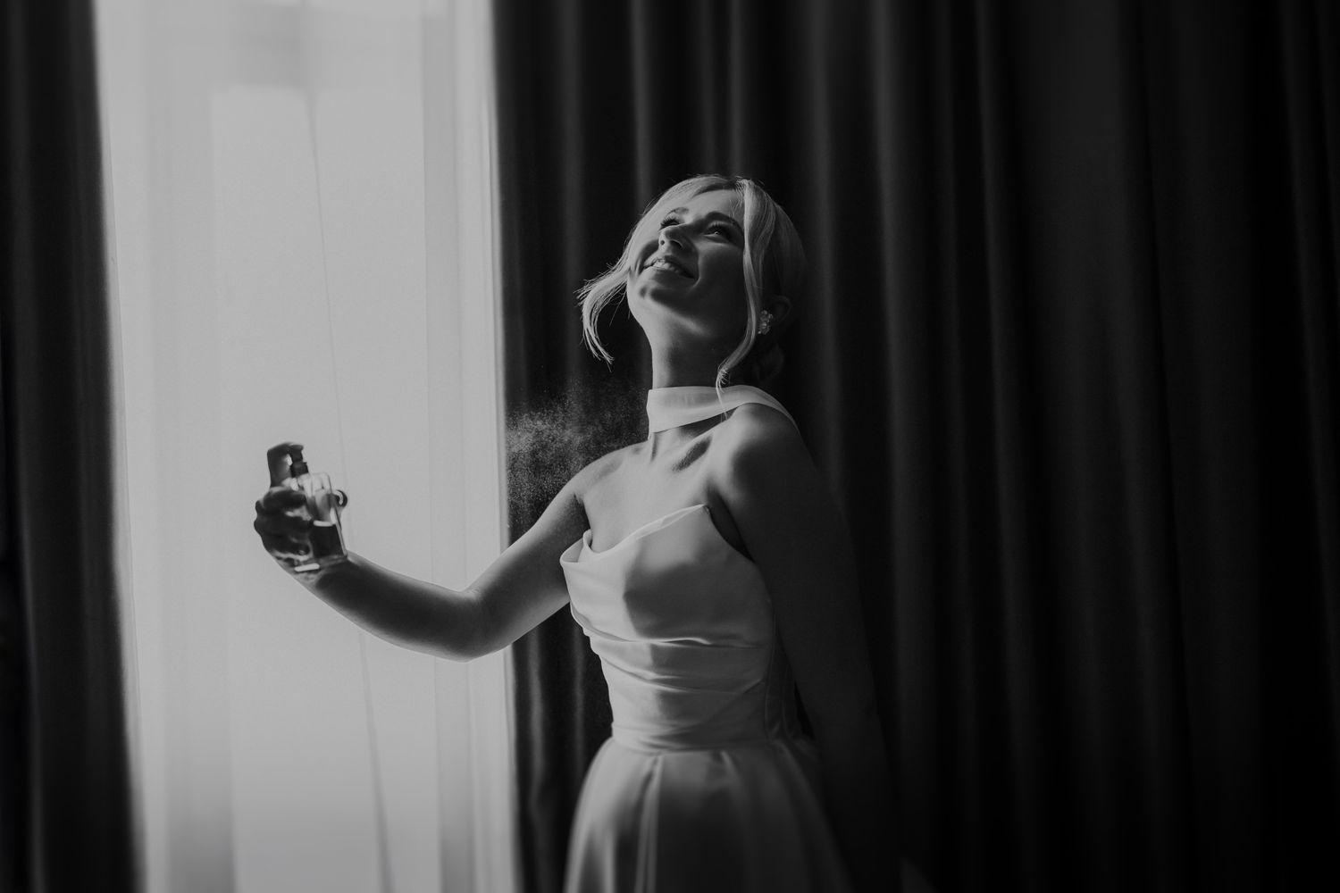 Dramatic black and white bridal portraits with moody lighting and curtains.