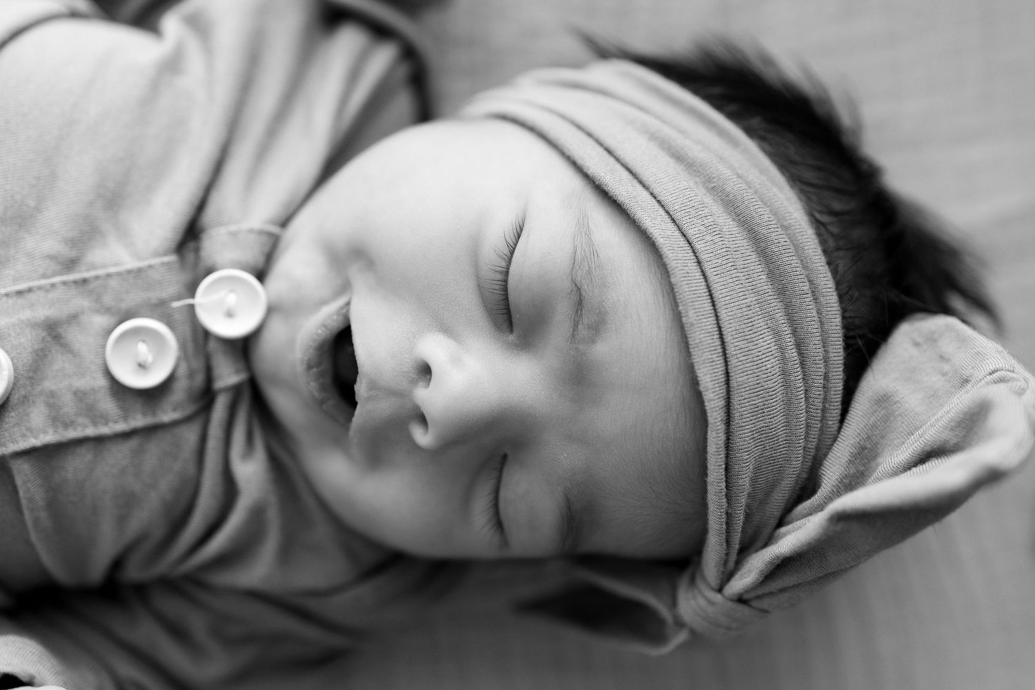 Series of black and white close-up shots showing sleeping baby with headband.