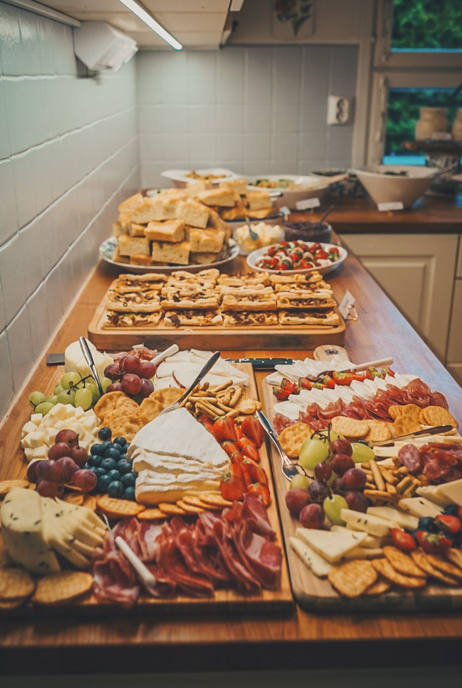 Gourmet charcuterie board display with meats, cheeses, fruits and crackers.