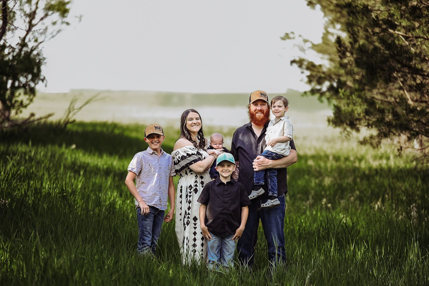 Family spending quality time outdoors together in a grassy field during golden hour.