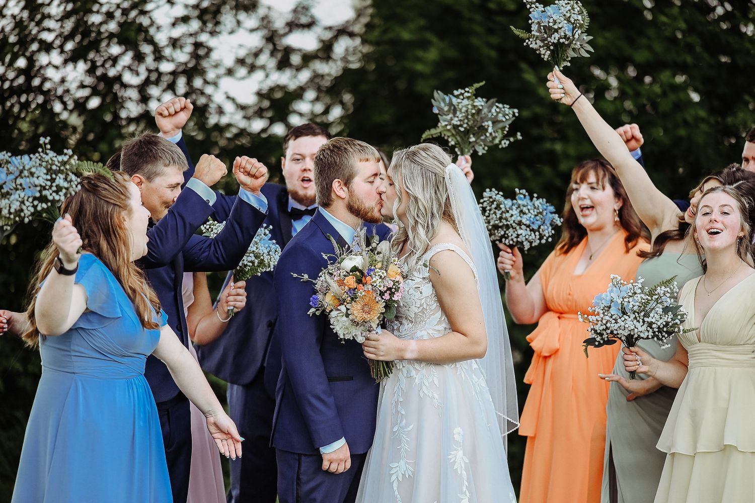 A series of candid wedding party photos showing joyful moments with bridesmaids in orange and yellow dresses.