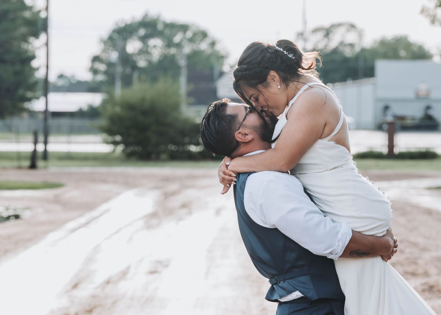 A couple embraces in casual outdoor setting during multiple emotional candid moments.