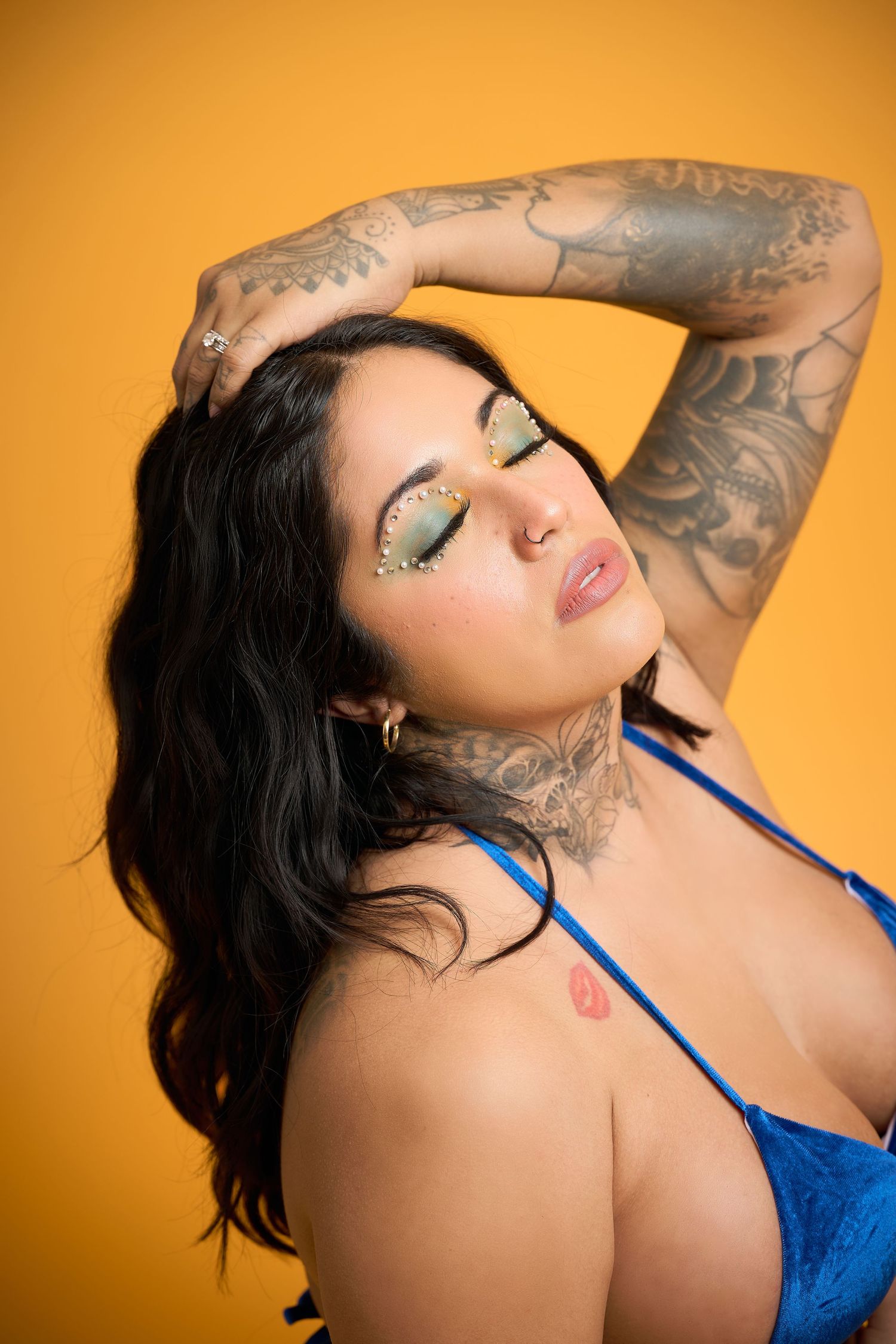 A series of artistic portraits showing dramatic poses against a vibrant orange backdrop, featuring blue attire and expressive poses.
