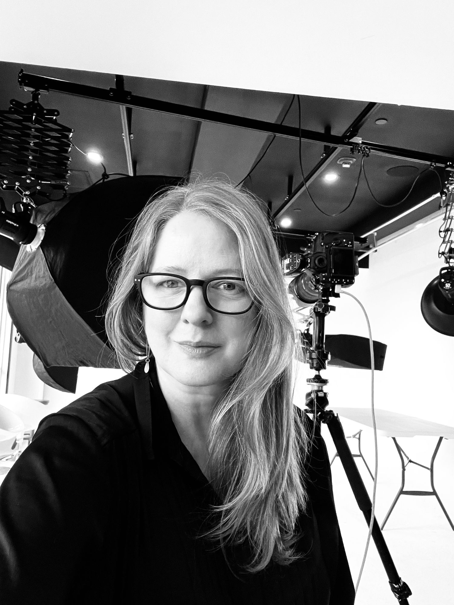 Bio photo of Linda Smallpage behind the scenes at a photo studio.