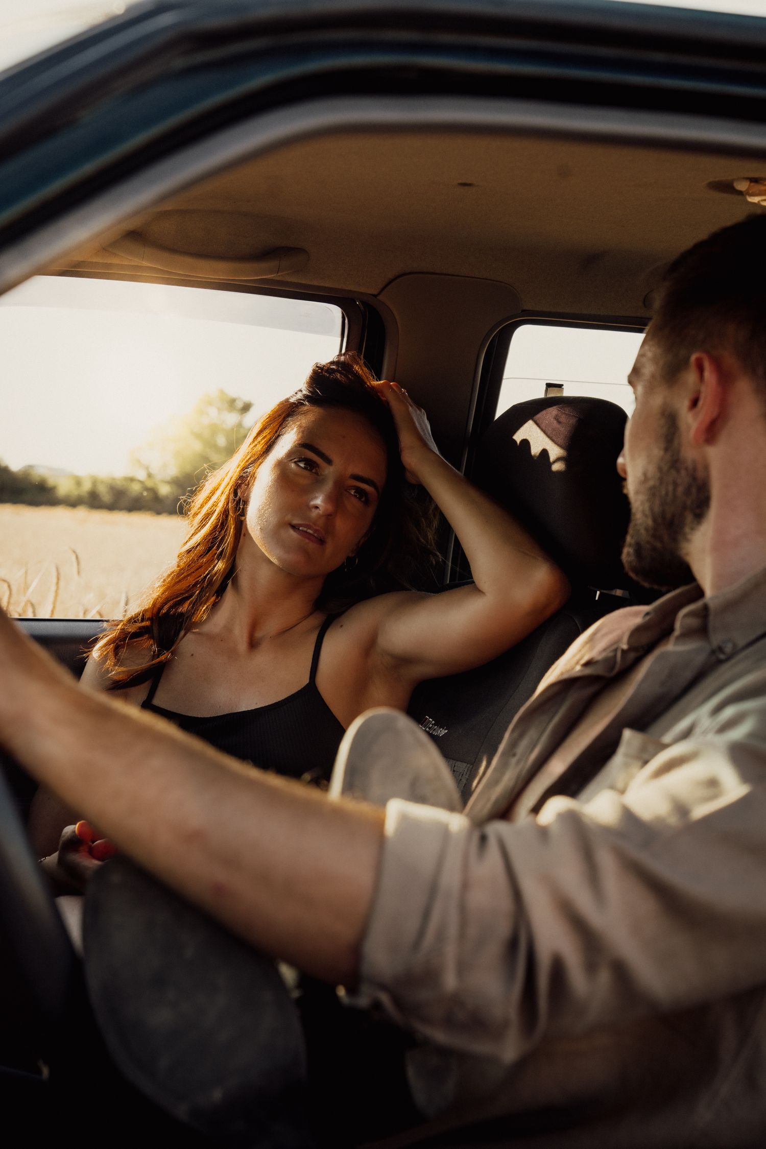 Intimate moment captured inside a vehicle during golden hour.