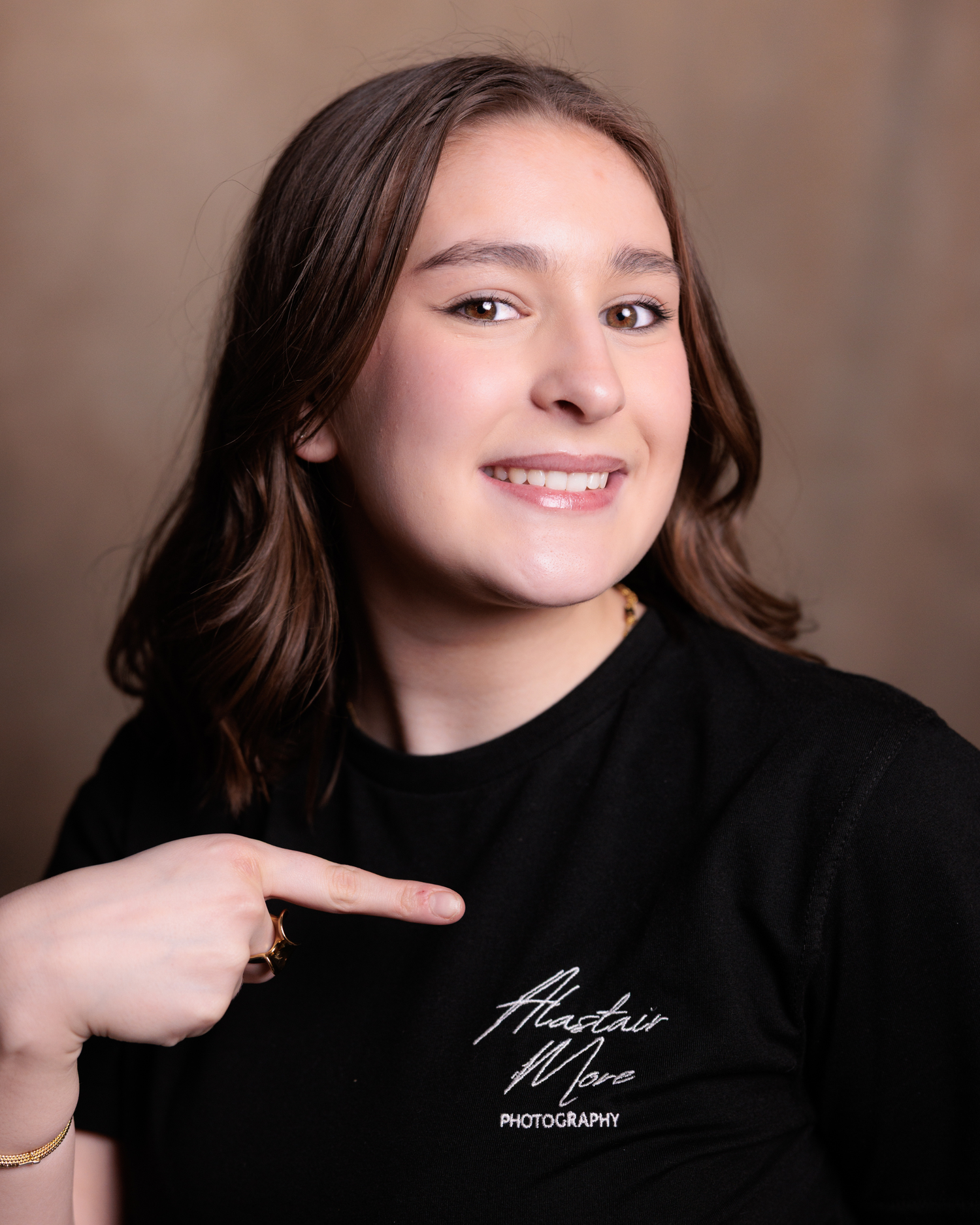A series of portrait photos showing someone in a black top against a brown background with varying poses and expressions.