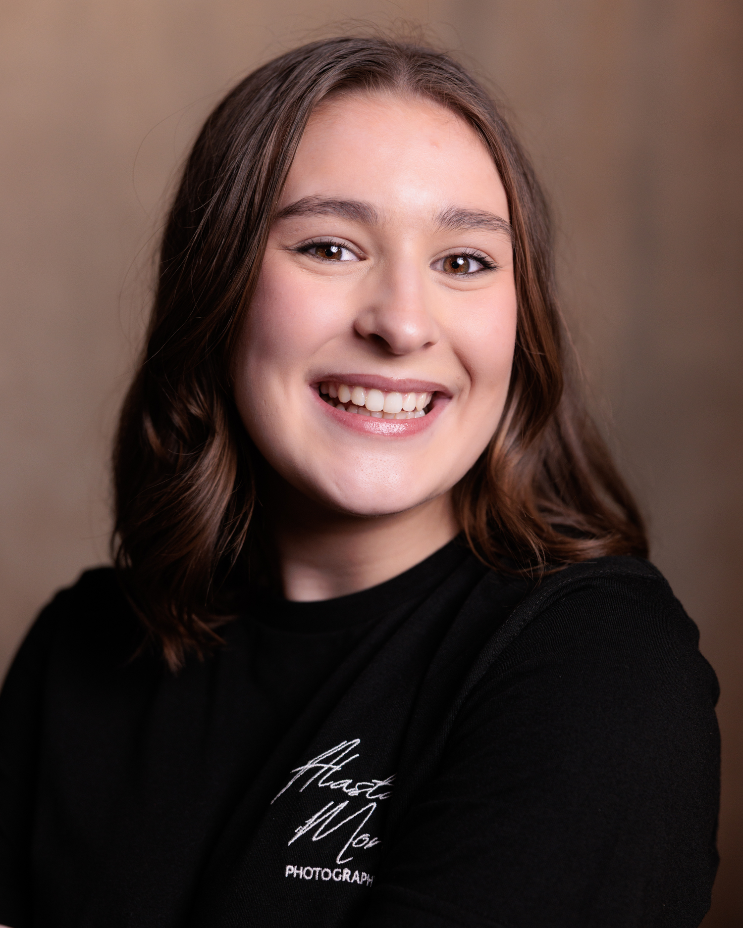 Portrait series showing different expressions and poses against a dark background in professional studio lighting.