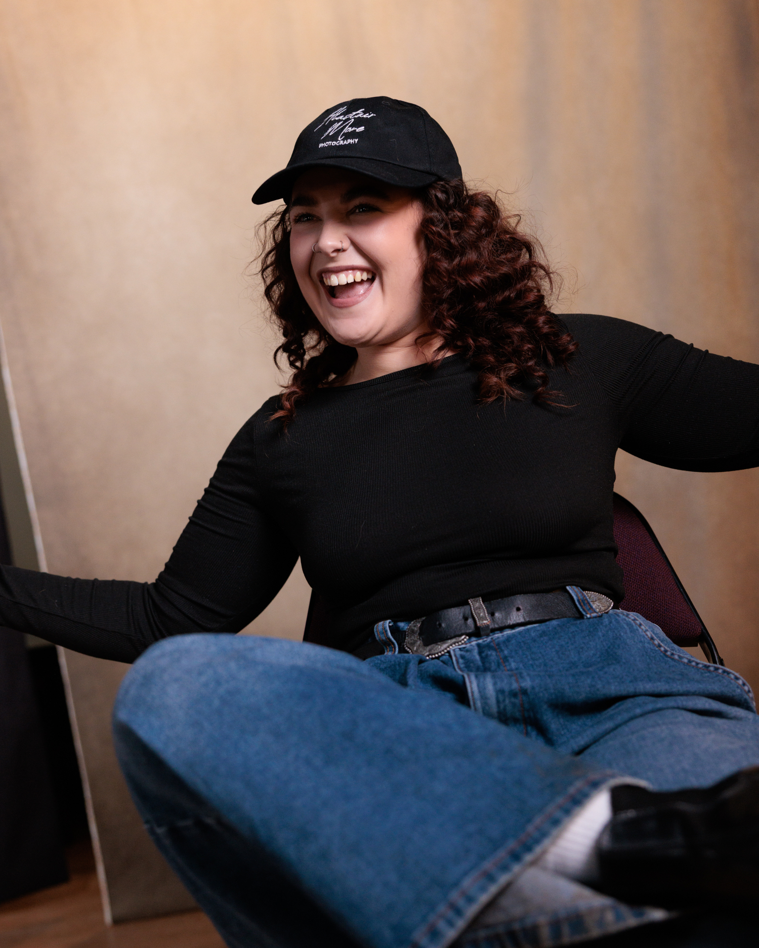 A sequence of six photos showing someone in black clothing and jeans playfully posing on a beige background.