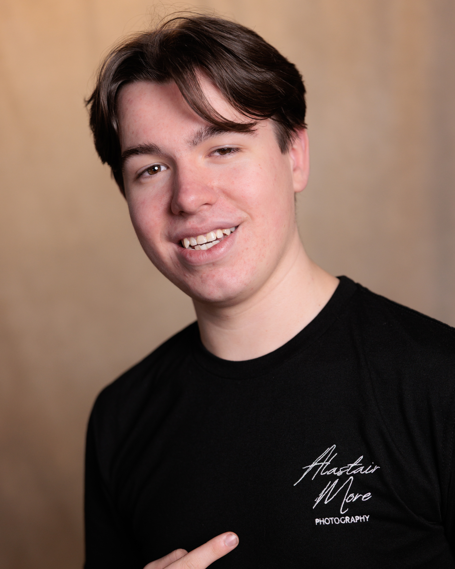 A series of professional headshot portraits showing someone wearing a black shirt against a neutral beige background.