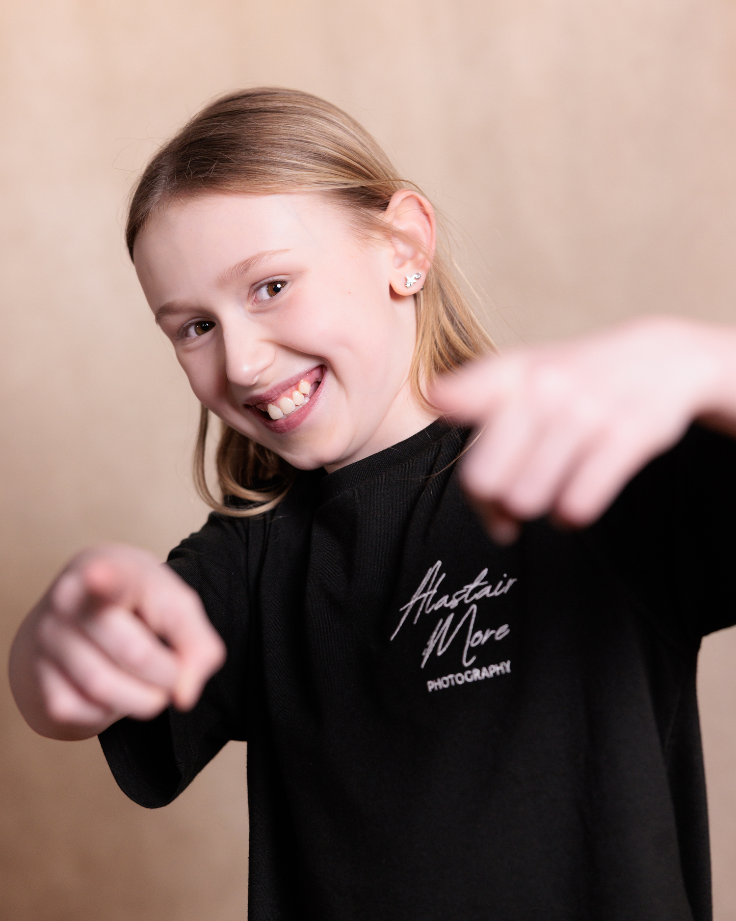 A series of five artistic portrait photos showing someone wearing a black turtleneck against a soft pink background.