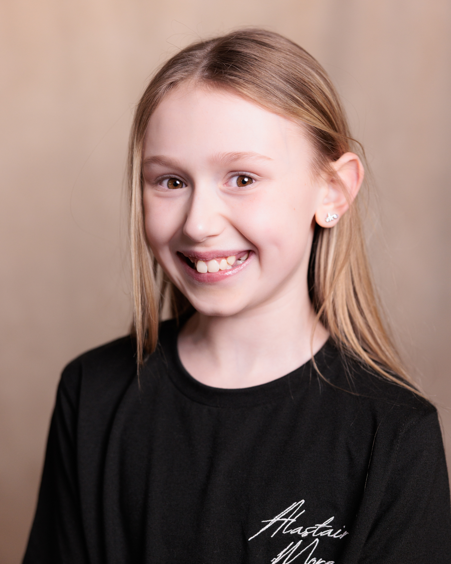 A series of headshots showing different expressions and poses against a neutral beige background.