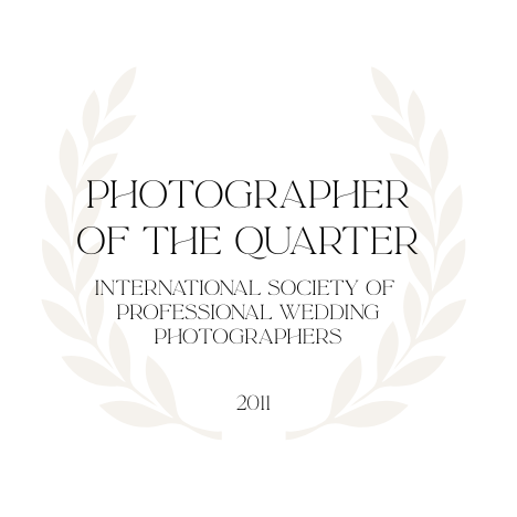 Professional wedding photographer award badge with laurel wreath design in gold and white colors.
