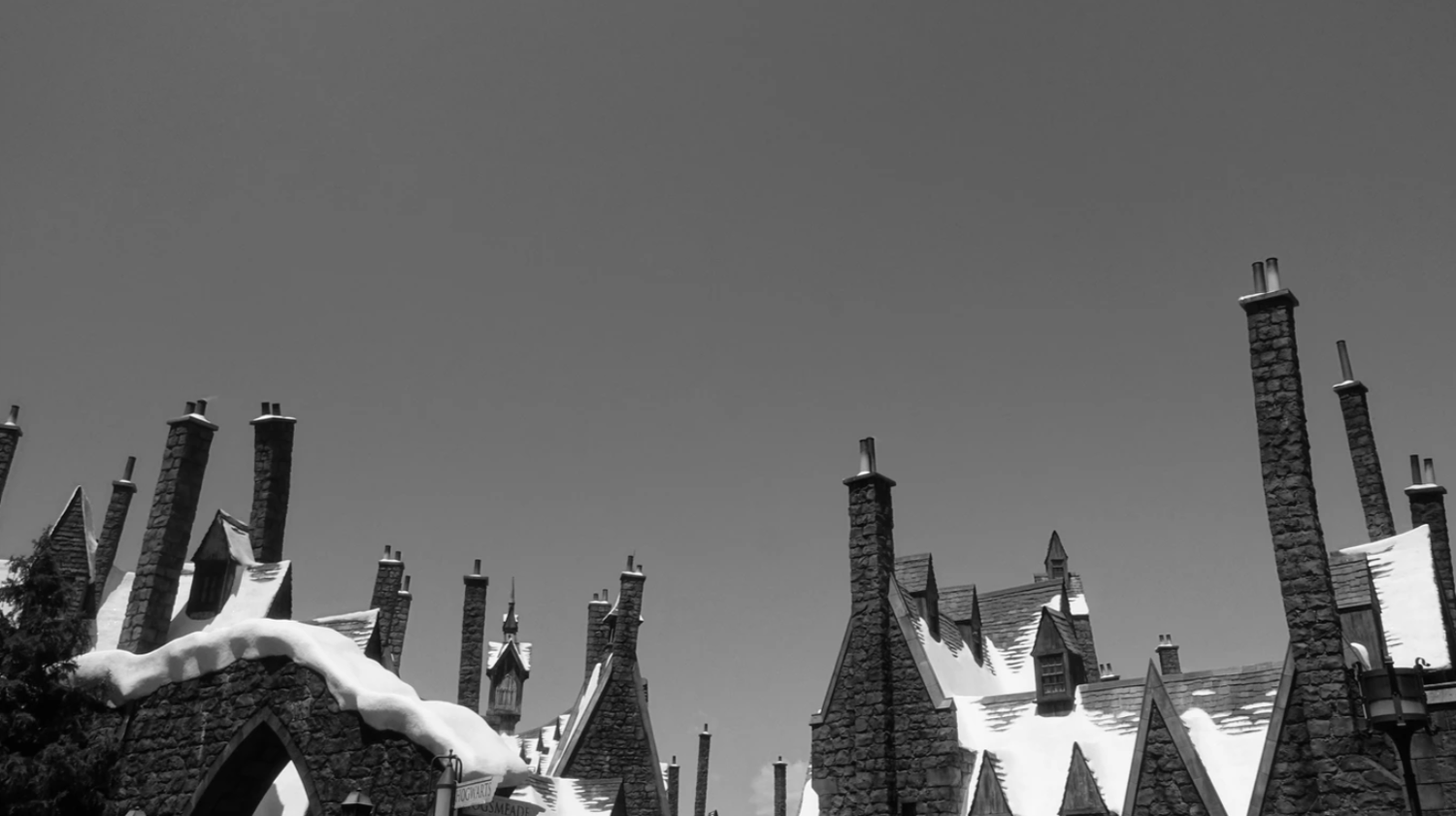 Black and white photo of medieval-style rooftops and chimneys at Hogsmeade Universal Studios.