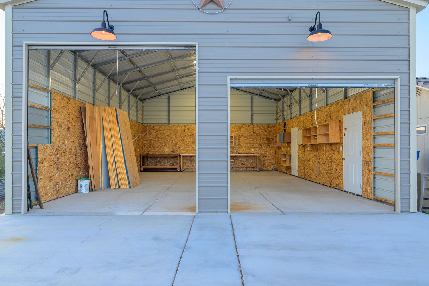 Interior view of an empty commercial warehouse space with concrete floors and exposed walls and ceiling.