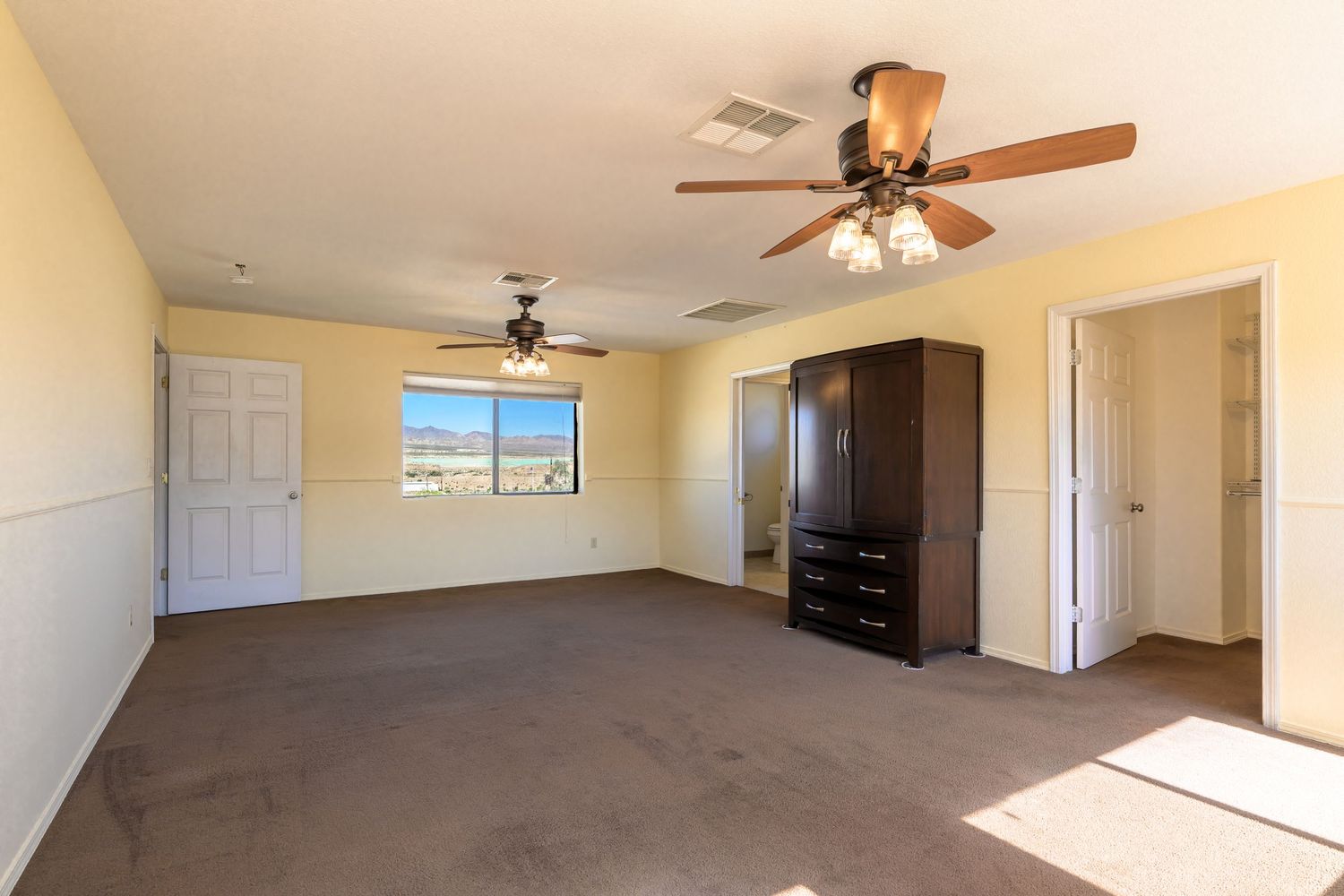 Collage of empty beige carpeted rooms with ceiling fans and white walls showing different angles of a residential space.